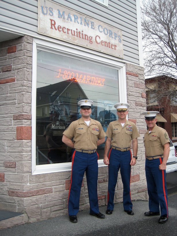Staff Sgt. Keith Lagasse, left, a canvassing recruiter at Permanent Contact Station Presque Isle, stands with Col. D.G. Goulet, center, the commanding officer of the 1st Marine Corps District, and Gunnery Sgt. Edward Powers, the staff noncommissioned officer-in-charge of Recruiting Substation Bangor, outside the Temporary Recruiting Facility in Madawaska, Maine.  Lagasse operates out of Presque Isle, Maine, by himself and is responsible for an area of operations bigger than many states.