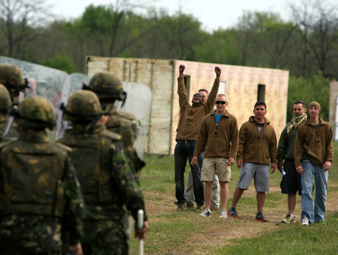 Black Sea Rotational Force 11 Marines, role-playing as “rioters” for a capabilities exercise, do their best to stir up aggression in Romanian Marines by throwing water bottles, fruit and taunts at the peacekeeping force heading into the urban training facility. Romanian and U.S. Marines trained in Babadag Training Area for a two-week course in counterinsurgency and peacekeeping operations including combat marksmanship, convoy operations, Improvised-Explosive Device (IED) awareness, and Marine Corps Martial Arts.::r::::n::