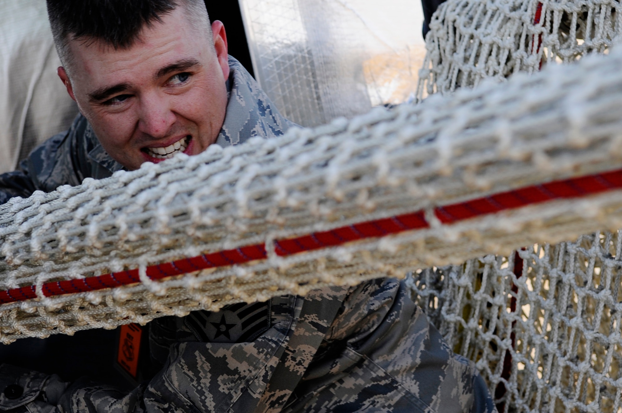 Staff Sgt. Michael Lantz pulls in the Baker Life Chute after a drill and familiarization exercise May 5, 2011, Eielson Air Force Base, Alaska. The chute provides a safe evacuation from a high rise building in the event of an emergency. Sergeant Lantz is an air traffic controller assigned to the 354th Operations Support Squadron. (U.S. Air Force photo/Airman 1st Class Laura Goodgame) 