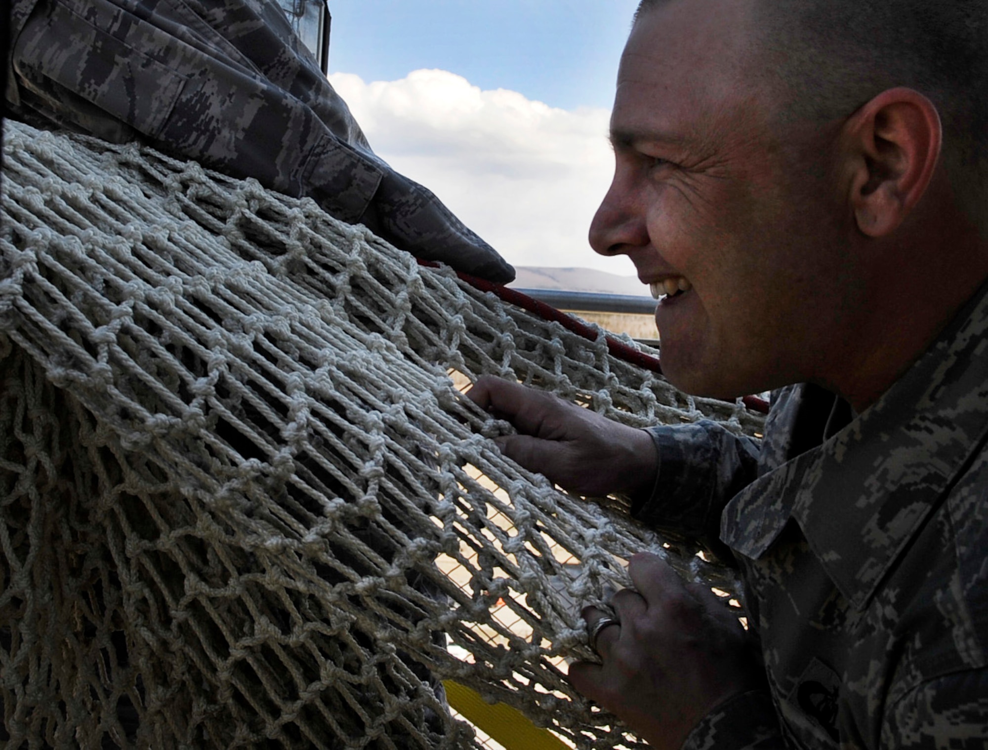 Tech. Sgt. Dustin Rogstad keeps a firm grip on a Baker Life-Chute during a drill and familiarization exercise May 5, 2011, Eielson Air Force Base, Alaska. The chute is a safe means for Airmen to escape the air traffic control tower in case of a fire or emergency. Sergeant Rogstad is an air traffic controller assigned to the 354th Operations Support Squadron. (U.S. Air Force photo/Airman 1st Class Laura Goodgame)