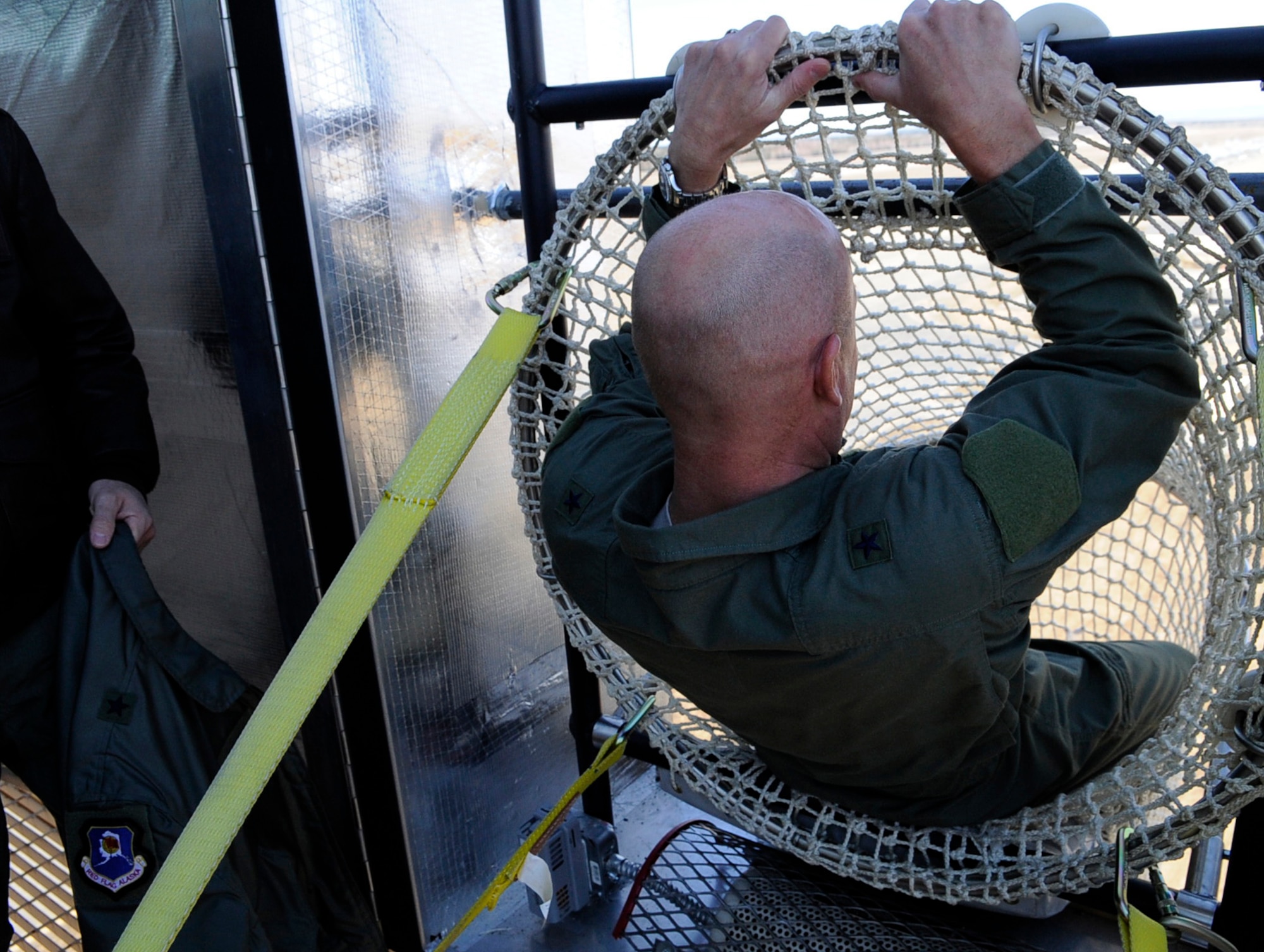 Brig. Gen. James N. Post III prepares to egress down the Baker Life Chute during a drill and familiarization exercise May 5, 2011, Eielson Air Force Base, Alaska. The chute is a tubular net that cradles the body for a safe emergency escape from high rise buildings. General Post is the 354th Fighter Wing commander.  (U.S. Air Force photo/ Airman 1st Class Laura Goodgame) 