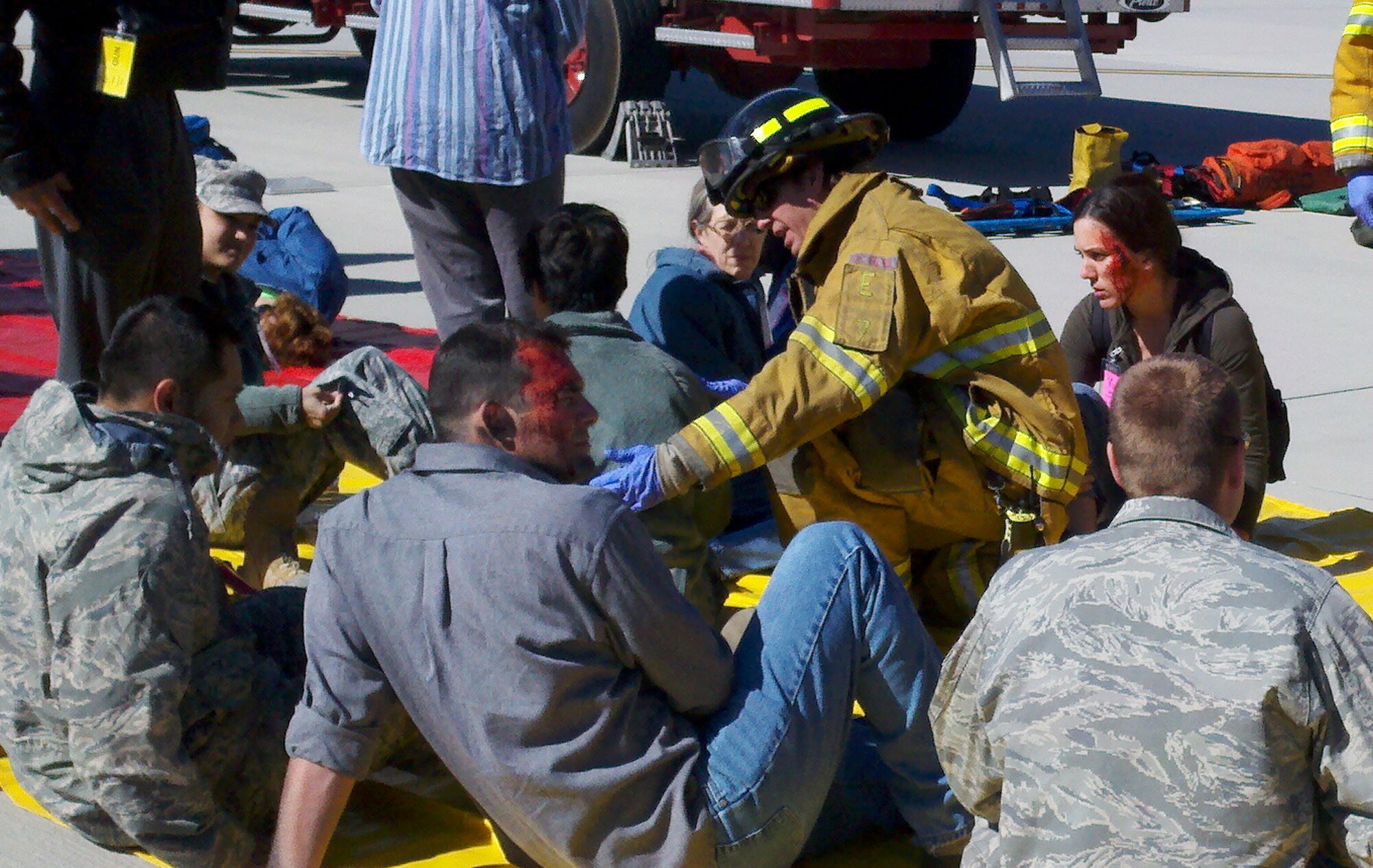 COLORADO SPRINGS, Colo. – 21st Space Wing Airmen await emergency assistance during a joint exercise between the 21st Space Wing and the Colorado Springs Airport May 5.  Emergency responders reacted to a simulated airplane crash at the airport during the exercise. Colorado Springs fire, police and other emergency responders also participated in the exercise, which is conducted every three years in an effort to update the joint emergency management plan. About 40 wing personnel participated as injured victims to assist in making the exercise as real as possible. The Air Force requires every wing to conduct quarterly exercises to test deployment operations, emergency response actions and compliance with Department of Defense, Air Force, Headquarters Air Force Space Command, and local instructions. (U.S. Air Force/ Tech. Sgt. Amanda Callahan)