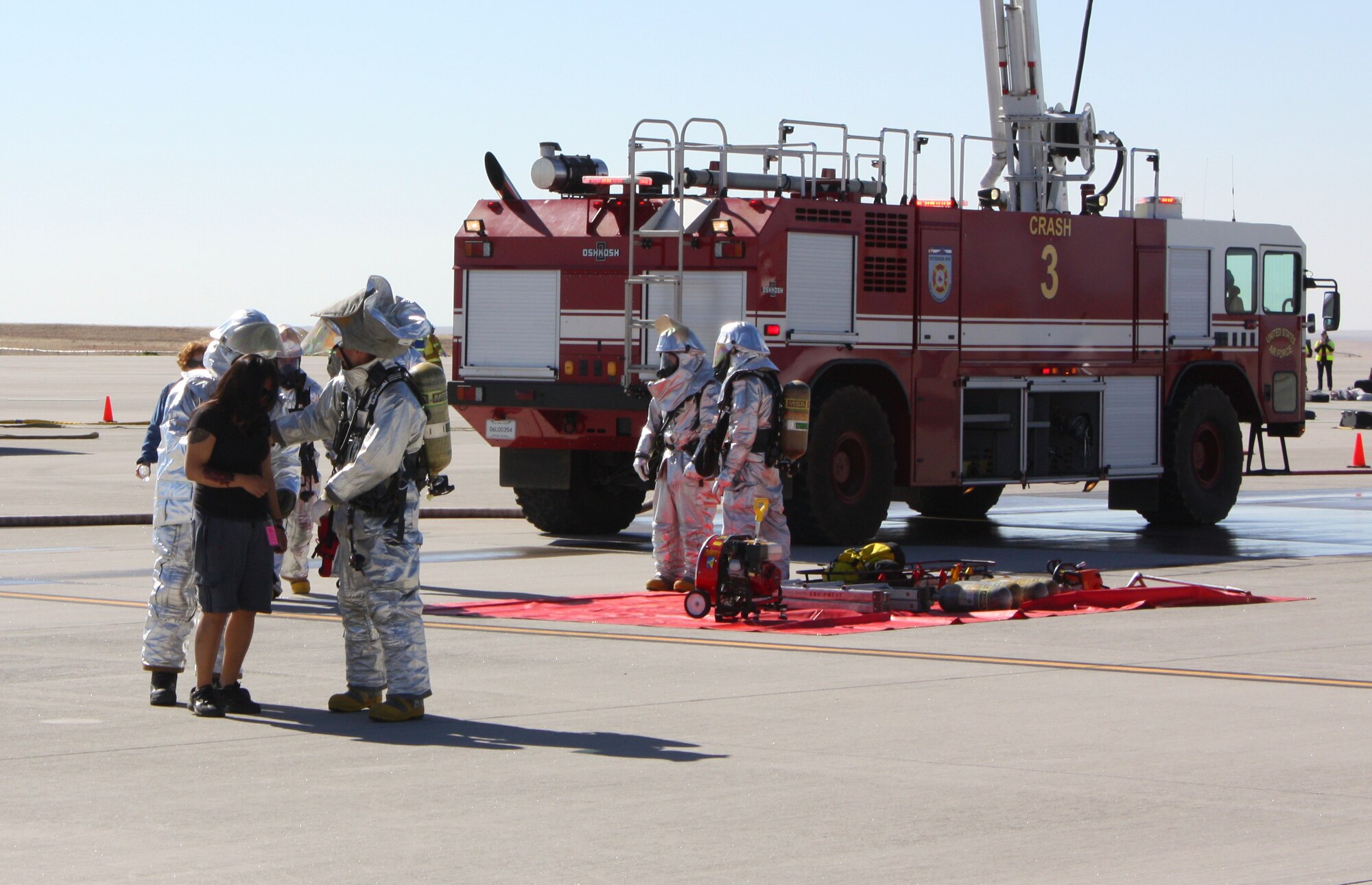 COLORADO SPRINGS, Colo. – Emergency responders react to a simulated airplane crash and assist volunteer victims May 5 at the Colorado Springs Airport during a joint exercise between the 21st Space Wing and the airport. Colorado Springs fire, police and other emergency responders also participated in the exercise, which is conducted every three years in an effort to update the joint emergency management plan. About 40 wing personnel participated as injured victims to assist in making the exercise as real as possible. The Air Force requires every wing to conduct quarterly exercises to test deployment operations, emergency response actions and compliance with Department of Defense, Air Force, Headquarters Air Force Space Command, and local instructions. (Courtesy photo/Kevin Meyer)