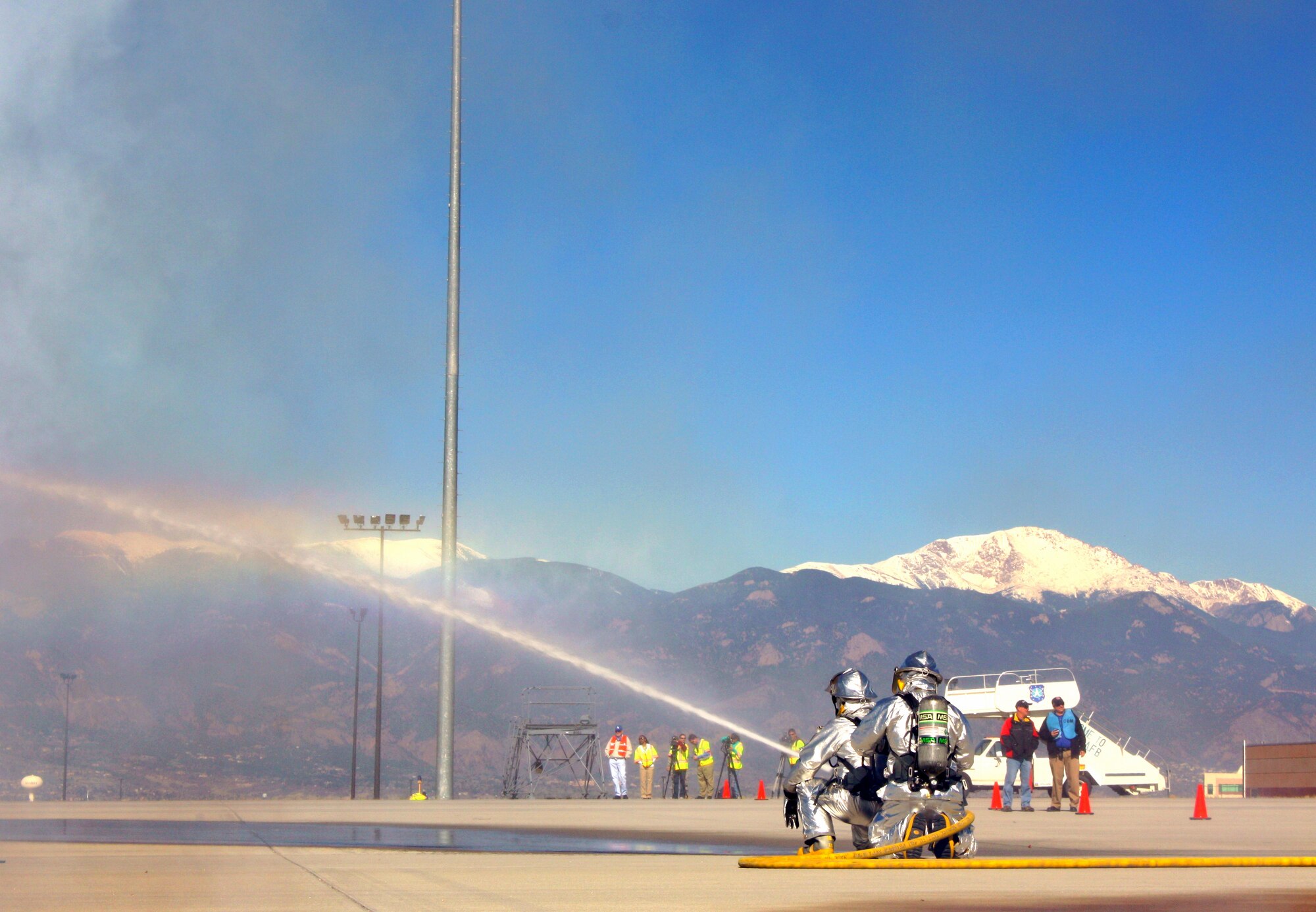 COLORADO SPRINGS, Colo. – Emergency responders react to a simulated airplane crash May 5 at the Colorado Springs Airport during a joint exercise between the 21st Space Wing and the airport. Colorado Springs fire, police and other emergency responders also participated in the exercise, which is conducted every three years in an effort to update the joint emergency management plan. About 40 wing personnel participated as injured victims to assist in making the exercise as real as possible. The Air Force requires every wing to conduct quarterly exercises to test deployment operations, emergency response actions and compliance with Department of Defense, Air Force, Headquarters Air Force Space Command, and local instructions. (Courtesy photo/Kevin Meyer)