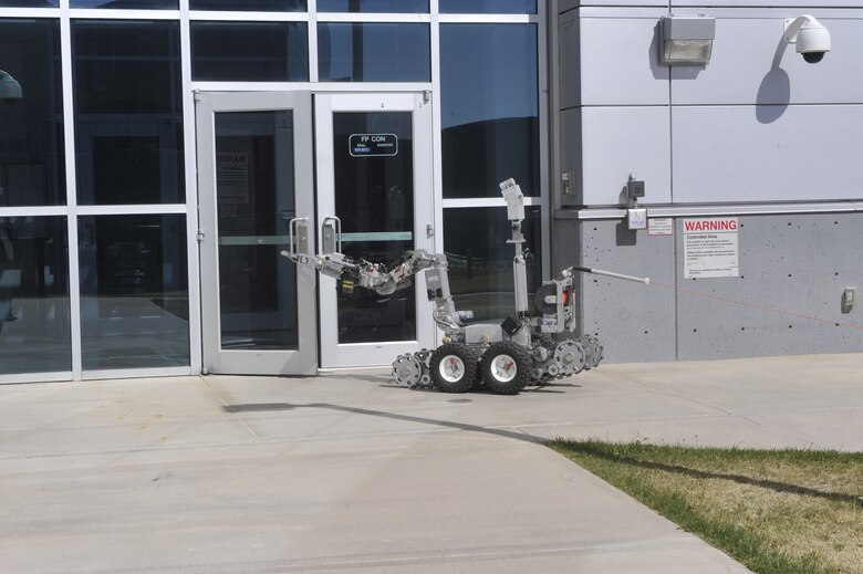 PETERSON AIR FORCE BASE, Colo.-- The 21st Space Wing Civil Engineer Squadron Explosive Ordnance Disposal’s F-6 Andros robot was deployed May 3 to the eastern entrance of Building 2 on Peterson Air Force Base during a joint exercise between the 21st SW and North American Aerospace Defense Command/U.S. Northern Command. The F-6 Andros, which can lift up to 100 pounds, was sent into the building after a “dirty bomb” exploded. The building had been evacuated and the robot recovered bits of the bomb. The Air Force requires every wing to conduct quarterly exercises to test deployment operations, emergency response actions and compliance with Department of Defense, Air Force, Headquarters Air Force Space Command, and local instructions. (U.S. Air Force photo/Robb Lingley)