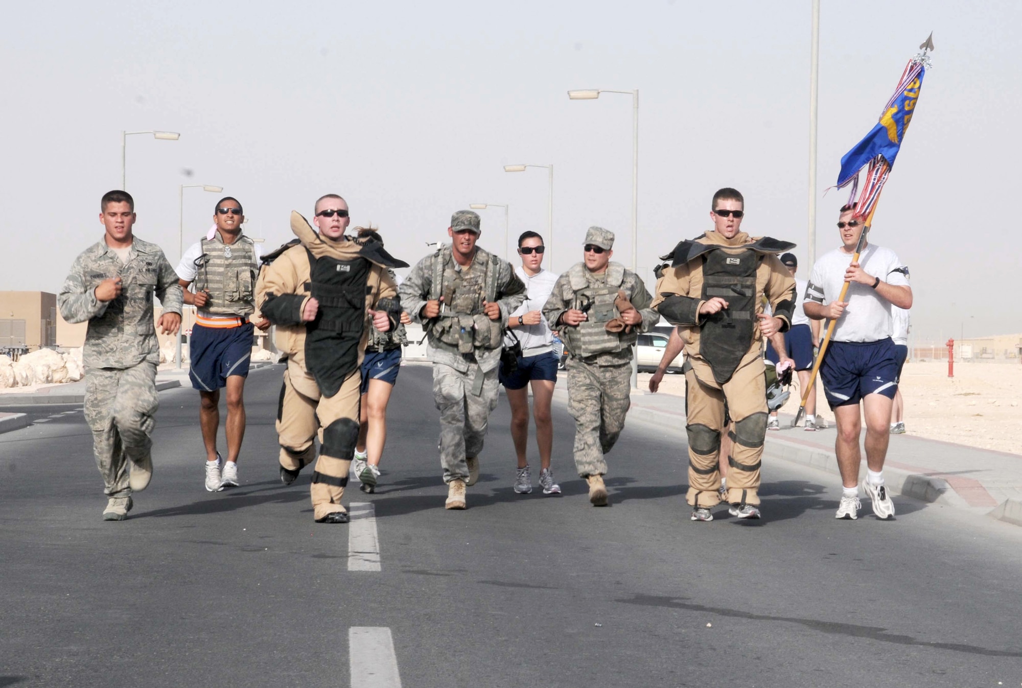 U.S. service members participate in a 5 km run hosted by the 379th Expeditionary Civil Engineering Squadron Explosive Ordnance Disposal team May 7, 2011, at an airbase in Southwest Asia. Many service members came to participate or cheer on the runners. (U.S. Air Force photo/Staff Sgt Anthony Graham)