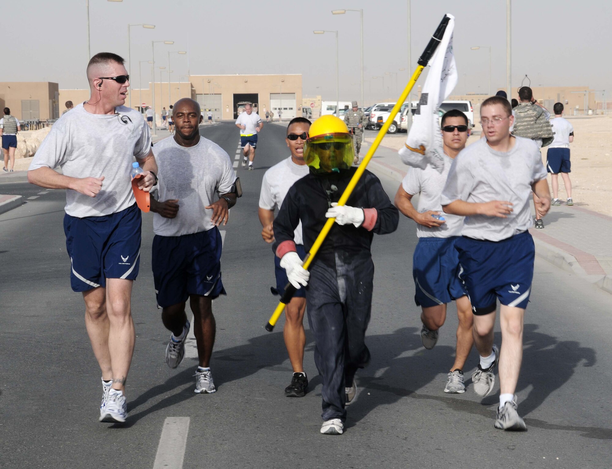 Airmen start the morning off with a 5 km run hosted by the 379th Expeditionary Civil Engineering Squadron Explosive Ordnance Disposal team May 7, 2011, at an airbase in Southwest Asia. Many service members came to participate or cheer on the runners. (U.S. Air Force photo/Staff Sgt Anthony Graham) 