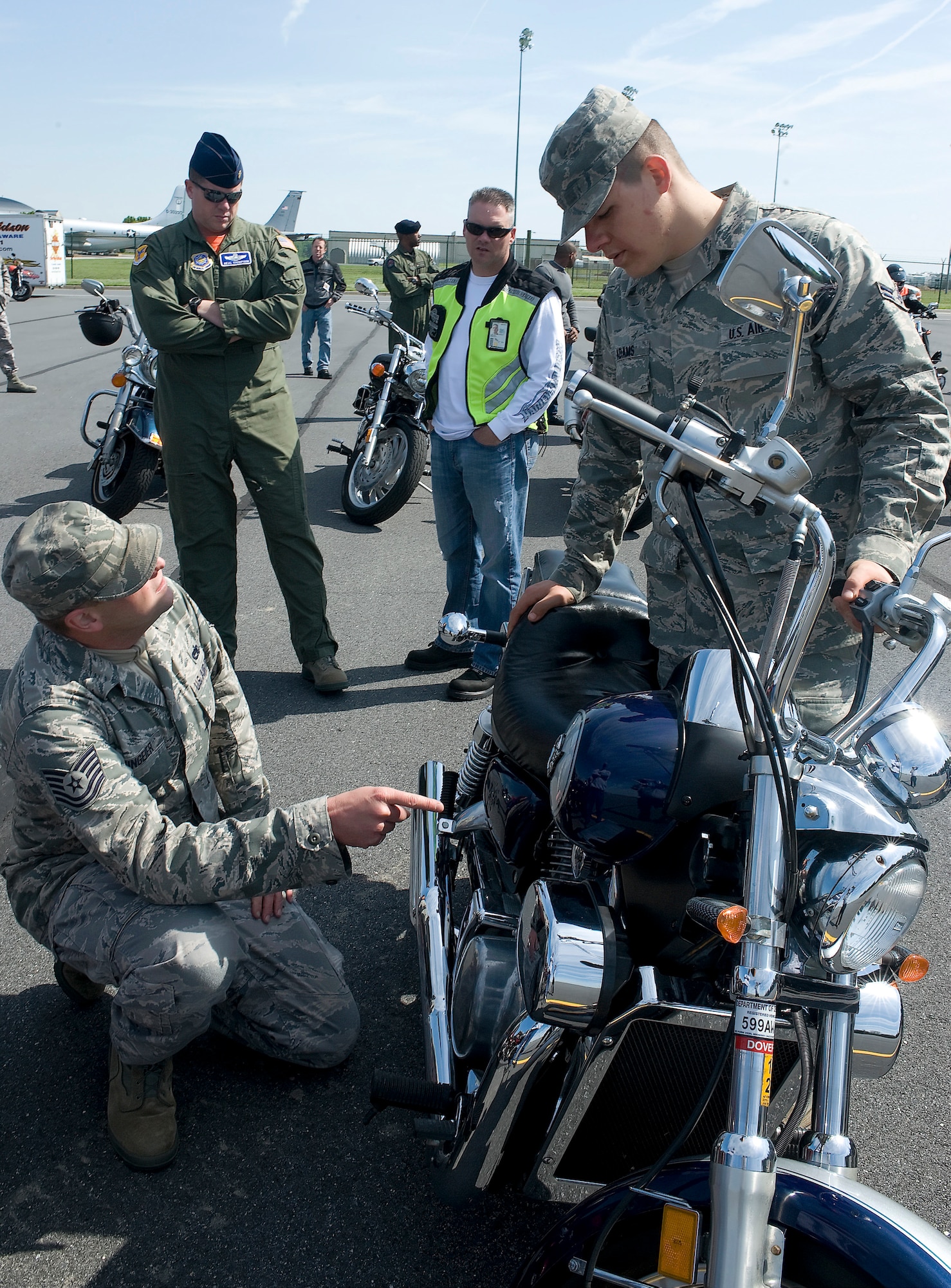 Team Dover members go over the mechanics of a motorcycle during Motorcycle Safety Awareness Day May 6, 2011, at the motorcycle range at Dover Air Force Base, Del. The day focused on ensuring all Team Dover motorcycle owners safely operate their vehicles. (U.S. Air Force photo by Steve Kotecki)