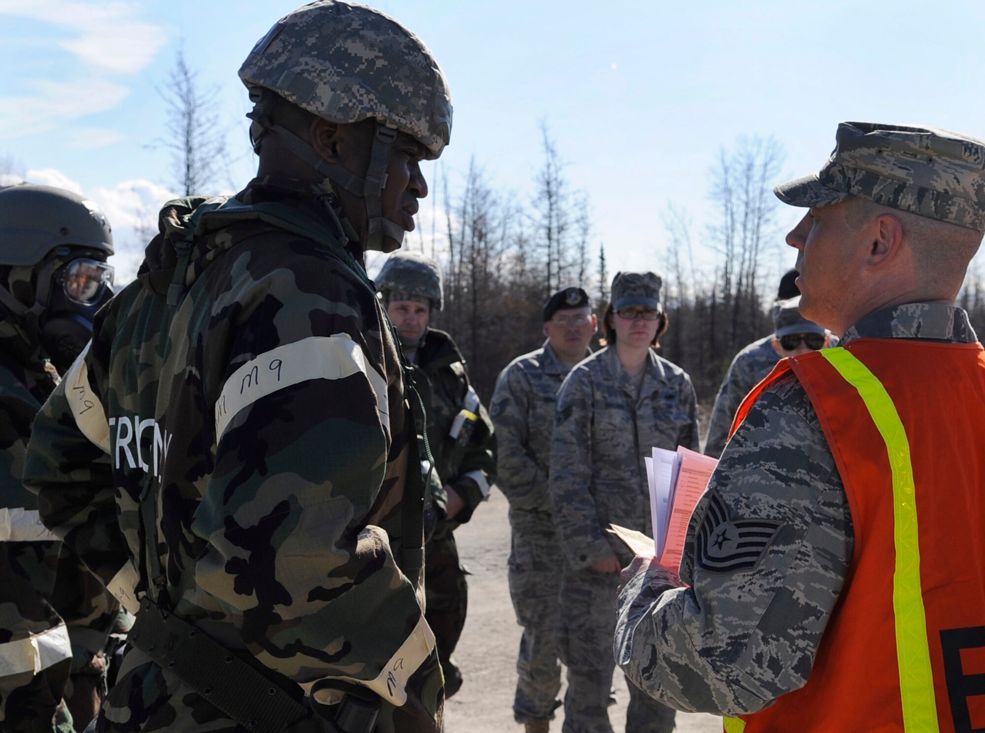 Chief Master Sgt. Jerry Moore listens closely to an evaluator's instructions given during an operational readiness exercise evaluation May 5, 2011, Eielson Air Force Base, Alaska. The evaluation tests Airmen's ability to survive and operate in a simulated chemical, biological, radiological, nuclear, and high yield explosive environment.  Chief Moore is the 354th Fighter Wing command chief master sergeant. (U.S. Air Force photo/Airman 1st Class Laura Goodgame)
