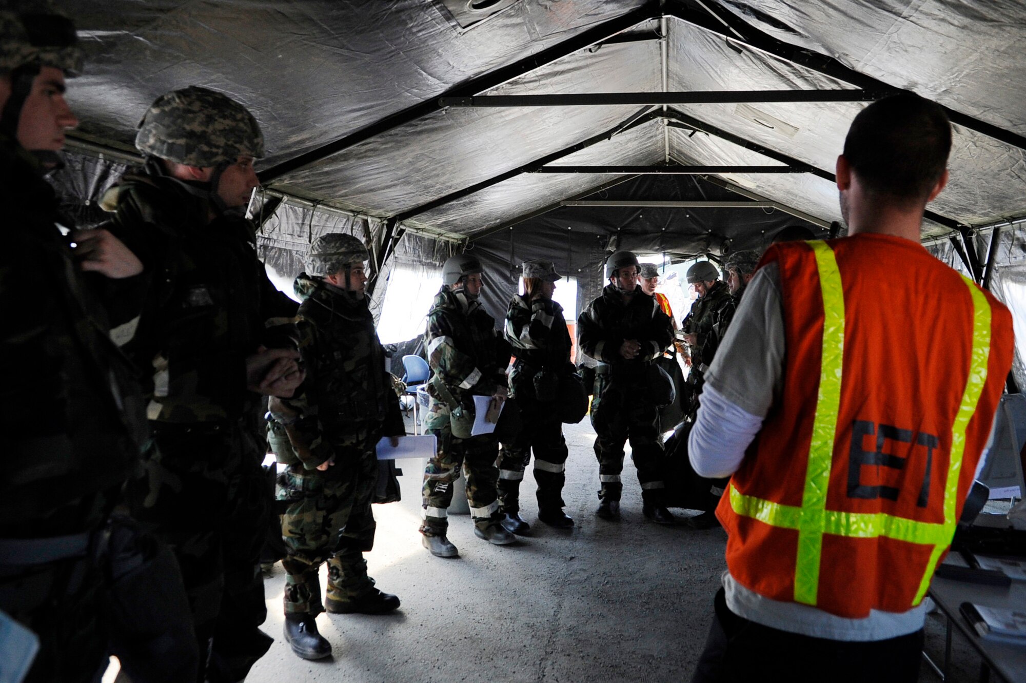 Airmen prepare to go through a weapons clearing evaluation during an operational readiness exercise May 5, 2011, Eielson Air Force Base, Alaska. The evaluation tests Airmen's ability to survive and operate in a simulated chemical, biological, radiological, nuclear, and high yield explosive environment.  (U.S. Air Force photo/Airman 1st Class Laura Goodgame) 
