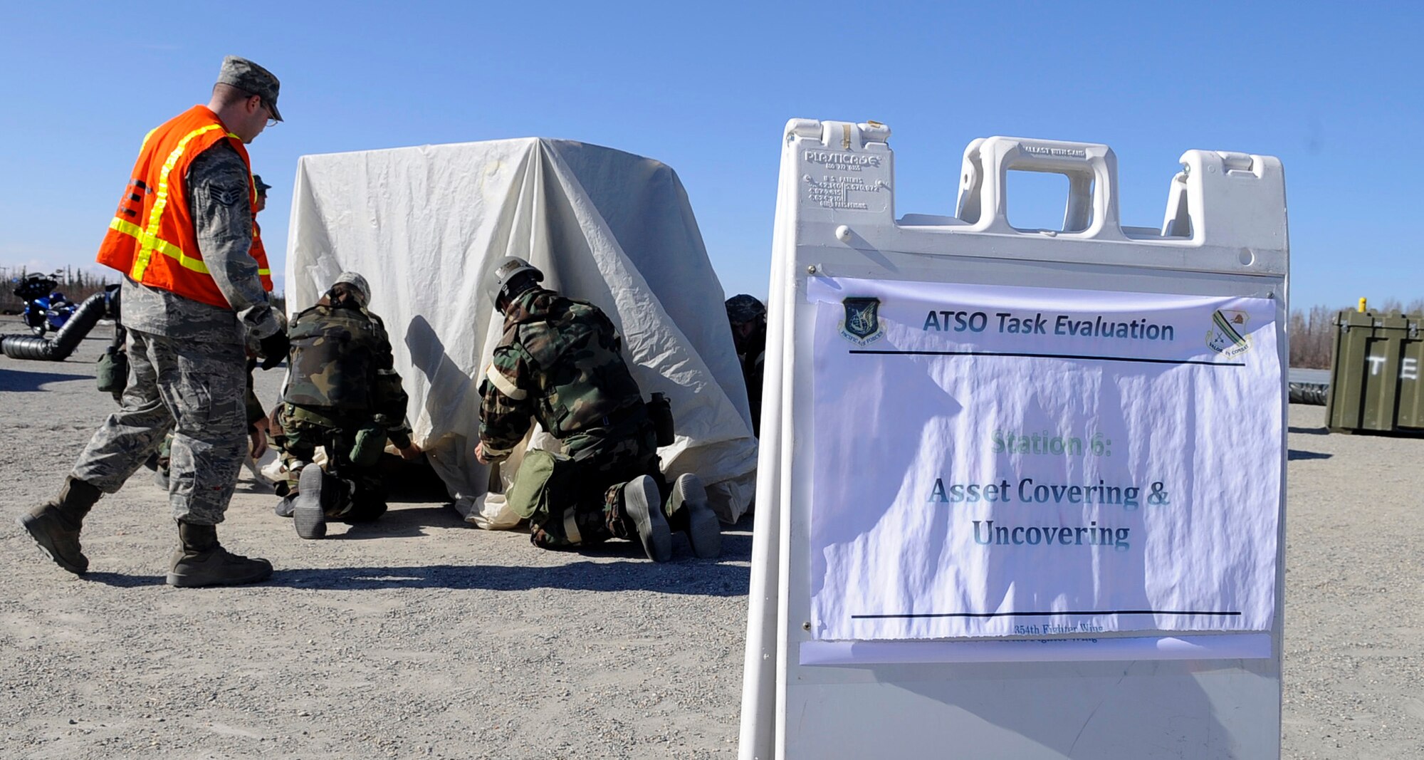 Airmen cover an asset during an operational readiness exercise evaluation May 5, 2011, Eielson Air Force Base, Alaska. The evaluation tests Airmen's ability to survive and operate in a simulated chemical, biological, radiological, nuclear, and high yield explosive environment.  (U.S. Air Force photo/Airman 1st Class Laura Goodgame)