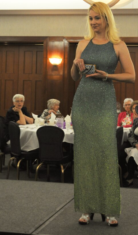 Sally Guild, a member of the Andrews Officer's Spouses Club, models a gown from the Andrews Thrift Shop.  The AOSC runs the shop, and distributes the proceeds back to the base and local community. (U.S. Air Force photo by Senior Airman Torey Griffith)