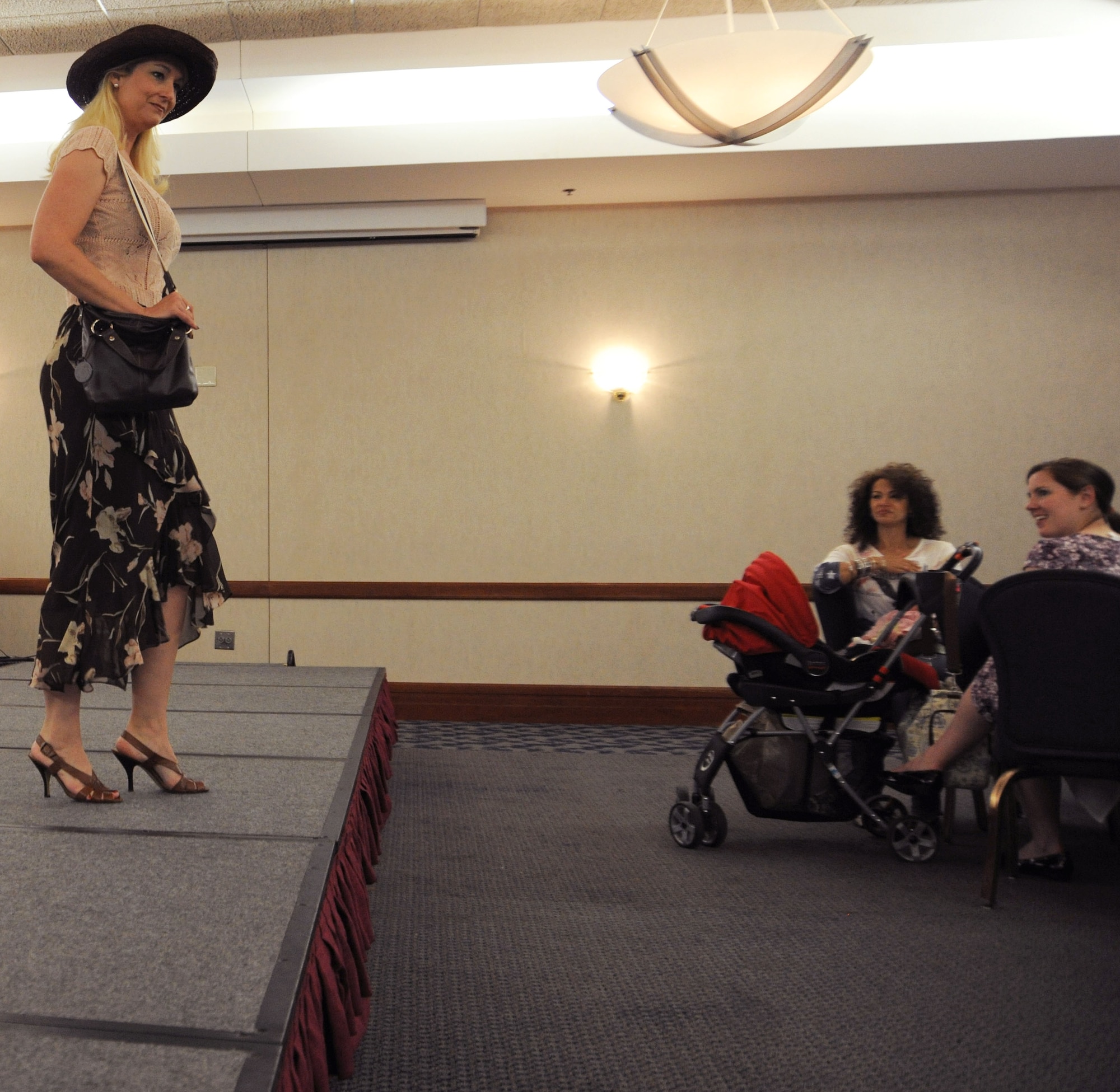 Sally Guild, a member of the Andrews Officer's Spouses Club, models summer clothing from the Andrews Thrift Shop.  The AOSC runs the shop, and distributes the proceeds back to the base and local community. (U.S. Air Force photo by Senior Airman Torey Griffith)(released)