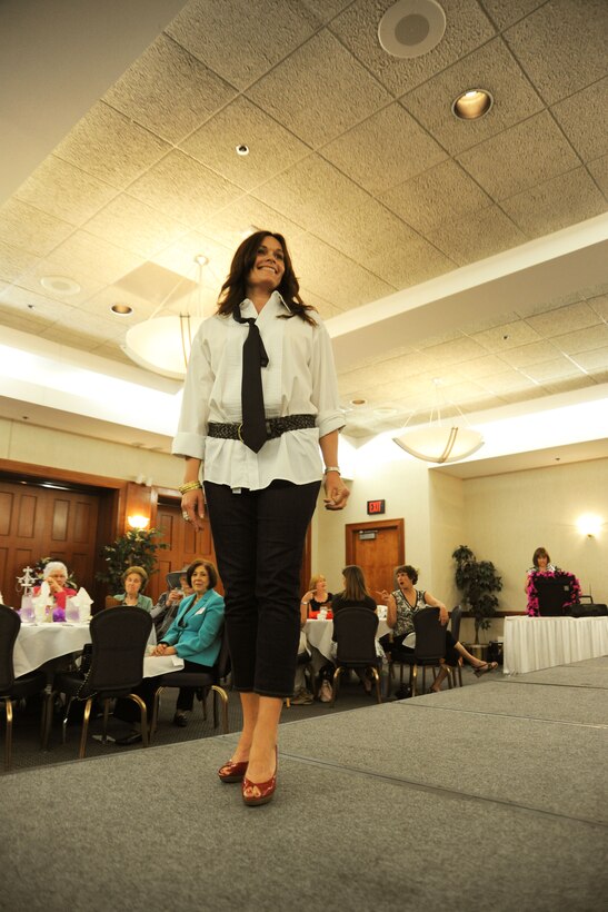 Louann Robinson, a member of the Andrews Officer's Spouses Club, models clothing from the Andrews Thrift Shop.  The AOSC runs the shop, and distributes the proceeds back to the base and local community. (U.S. Air Force photo by Senior Airman Torey Griffith)(released)