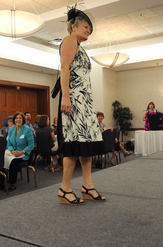 Pat Cramer, a member of the Andrews Officer's Spouses Club, models a dress and hat from the Andrews Thrift Shop.  The AOSC runs the shop, and distributes the proceeds back to the base and local community. (U.S. Air Force photo by Senior Airman Torey Griffith)