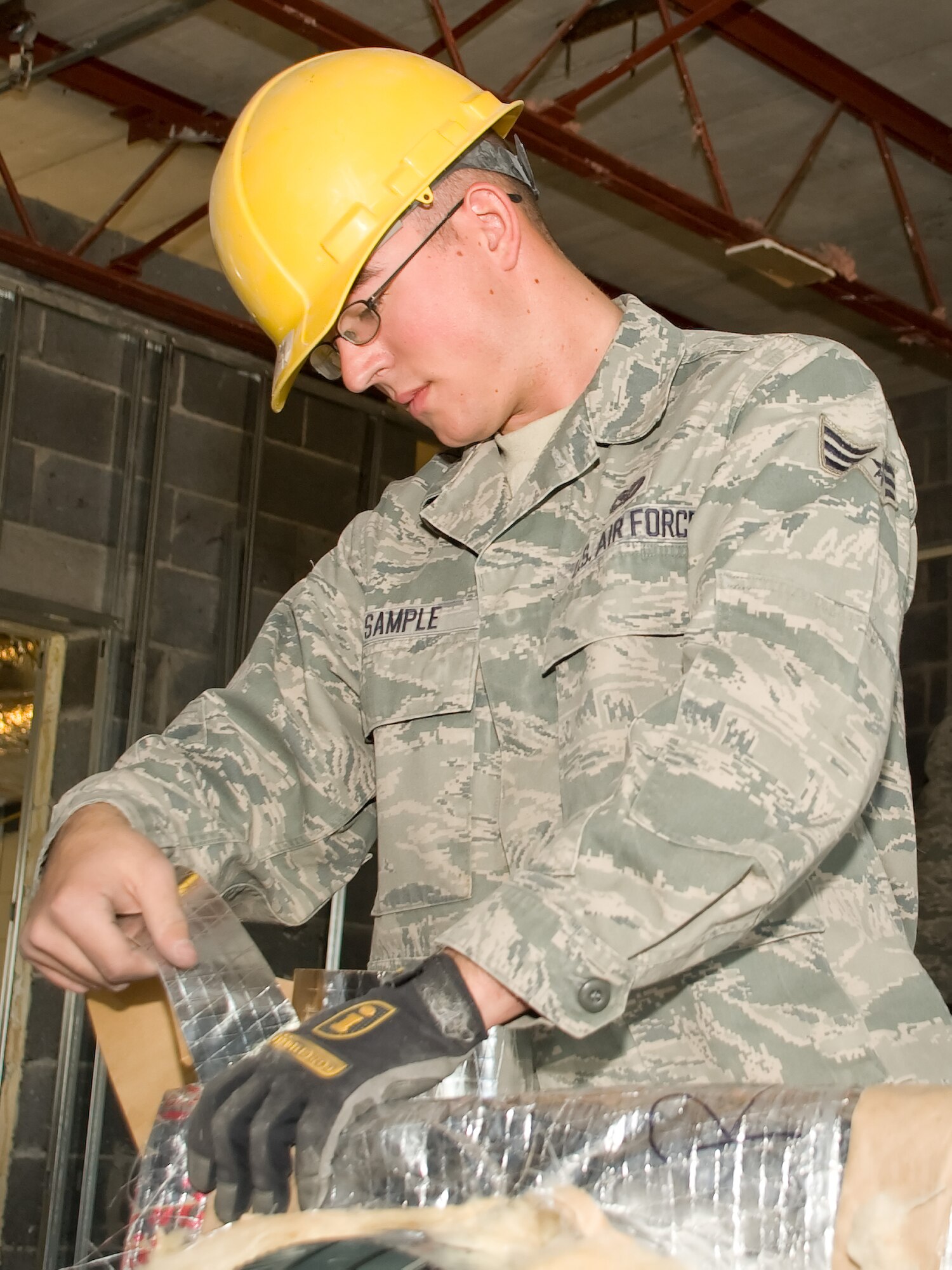 Senior Airman Daniel Sample, 436th Civil Engineer Squadron, prepares ventilation systems May 6, 2011, at the Honor Guard facility at Dover Air Force Base, Del. The original building was gutted of its fixtures and completely updated. (U.S. Air Force photo by Adrian Rowan)