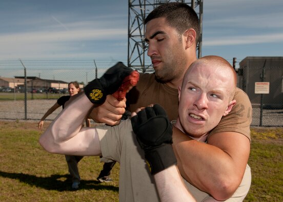 MOODY AIR FORCE BASE, Ga. -- Airman Jason Crawford, 823rd Base Defense Squadron fireteam member, brakes a choke hold from Senior Airman Kyle Simone, 23rd Security Forces Squadron patrolman, while attempting to disarm him during Krav Maga training at Moody Air Force Base, Ga., April 5. One of the techniques taught to the Airmen during the training was to successfully disarm an attacker without being harmed. (U.S. Air Force photo/Airman 1st Class Joshua Green)