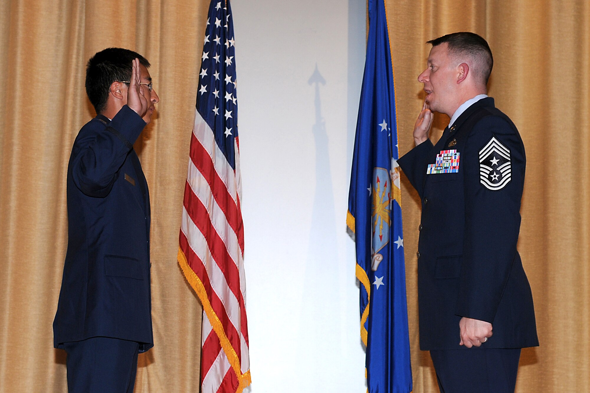 2nd Lt. Timothy Ramig, 17th Security Forces Squadron, administers the Oath of Enlistment to Chief Master Sgt. Brendan Criswell, 17th Training Wing Command Chief during the Stars and Stripes ceremony April 29. (U.S. Air Force photo/Staff Sgt. Heather Rodgers).