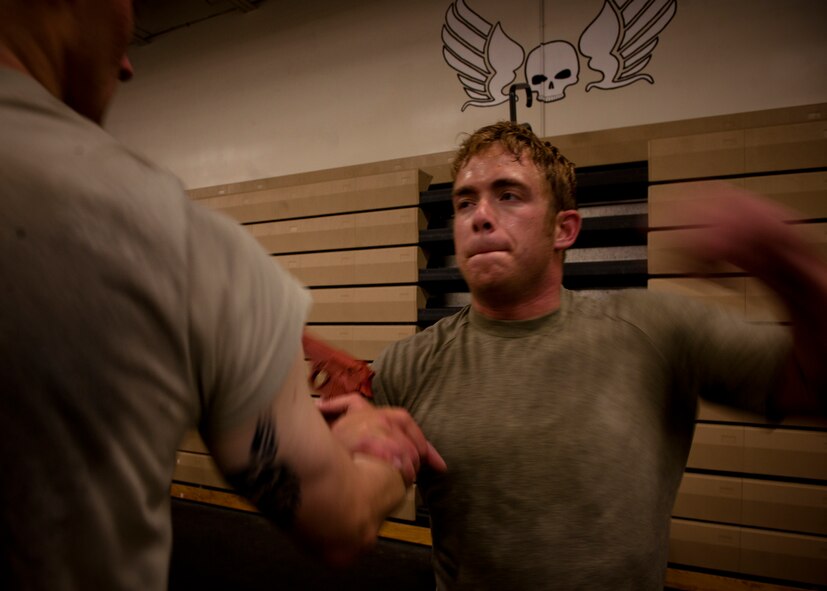 MOODY AIR FORCE BASE, Ga.-- Staff Sgt. Alfonte Thomas, 823rd Base Defense Squadron fireteam member, throws a punch toward his attacker before disarming his weapon during Krav Maga training April 5. Krav Maga is a simple, effective self-defense system that emphasizes instinctive movements, practical techniques and realistic training scenarios. (U.S. Air Force photo/Airman 1st Class Joshua Green)(RELEASED)
