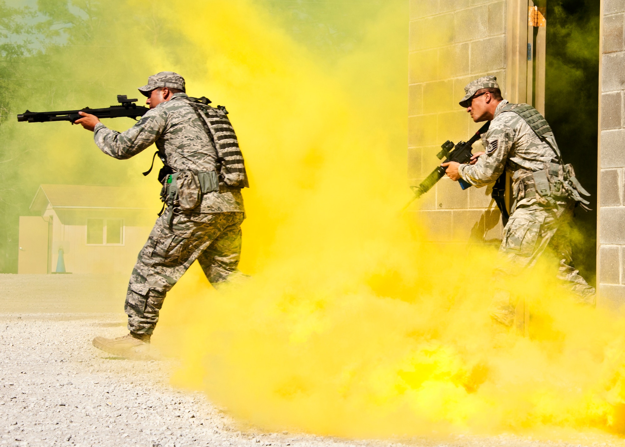 Staff Sgt. Geovanii Pacheco leads his team out of the building as part of a assault demonstration by the 96th Ground Combat Training Squadron May 6, 2011, at Eglin Air Force Base, Fla. The demonstration was for Chief Master Sgt. of the Air Force James A. Roy during his tour of the squadron facilities. The chief received a hands-on "Brave Defender" experience with the 96th GCTS, firing weapons, watching demonstrations and driving a humvee through a village with simulated improvised explosive devices. Sergeant Pacheco is a member of the 96th Ground Combat Training Squadron. (U.S. Air Force photo/Samuel King Jr.)
