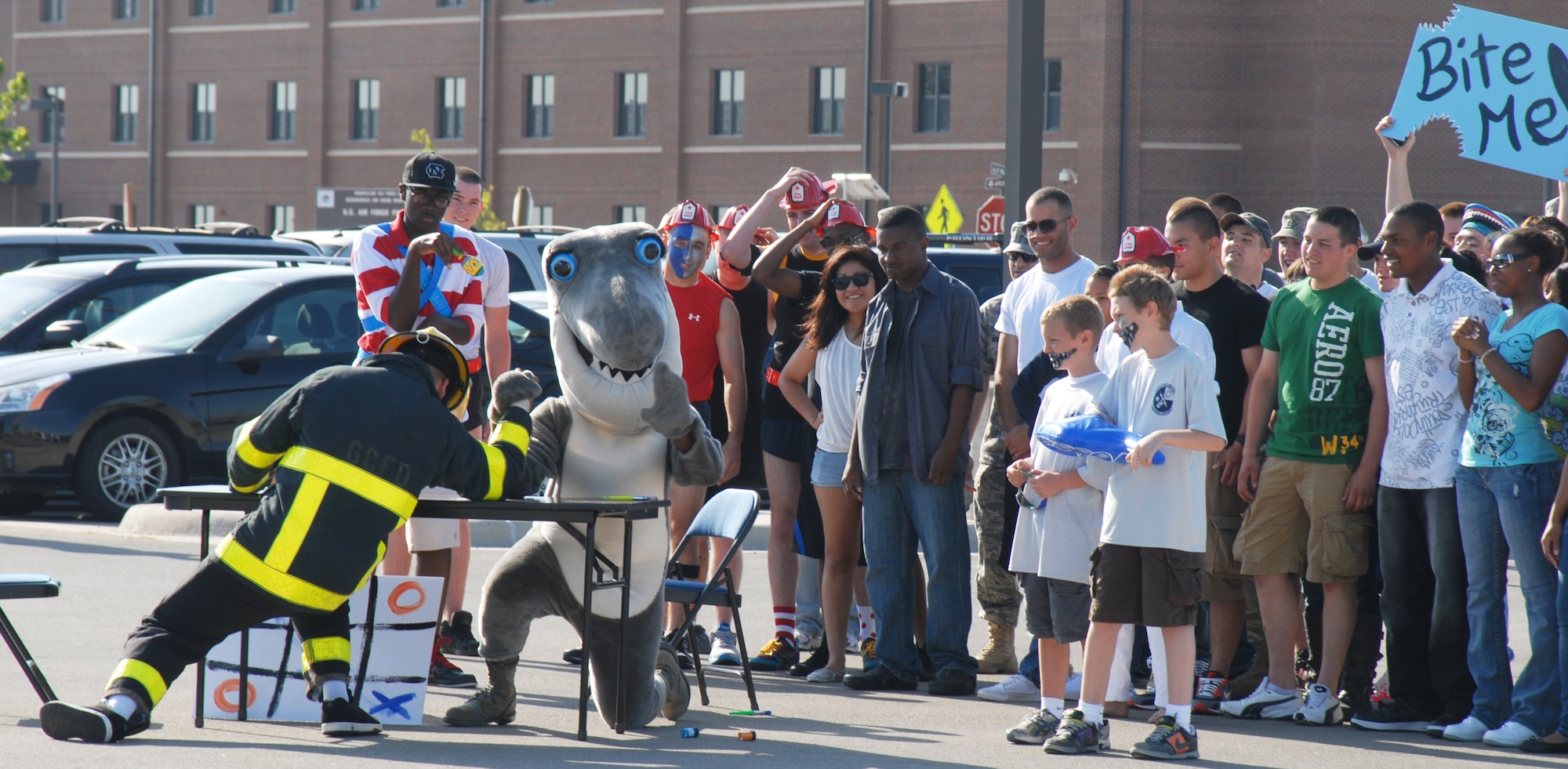 GOODFELLOW AIR FORCE BASE, Texas -- The 316th Training Squadron mascot, the shark, goes head to head in an arm wrestling match against a firefighter at the drill competition, May 7, 2011. The skit was used to demonstrate squadron spirit.(U.S. Air Force photo/Airman 1st Class Michael Smith)
