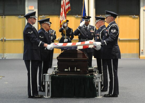 McConnell Honor Guard members perform a 20-man mock active duty funeral during their graduation ceremony May 4, 2011, McConnell Air Force Base, Kan.  Four members of the U.S. Air Force Honor Guard from Joint Base Anacostia-Bolling, Washington, D.C., spent 65 hours training the honor guard members on military funeral honors. Training for an active duty funeral included responsibilities and requirements for the NCOIC, pallbearers and the firing party; the proper flag folding sequence; presenting the colors and the significance of Taps. (U.S. Air Force Photo/Airman 1st Class Katrina M. Brisbin)