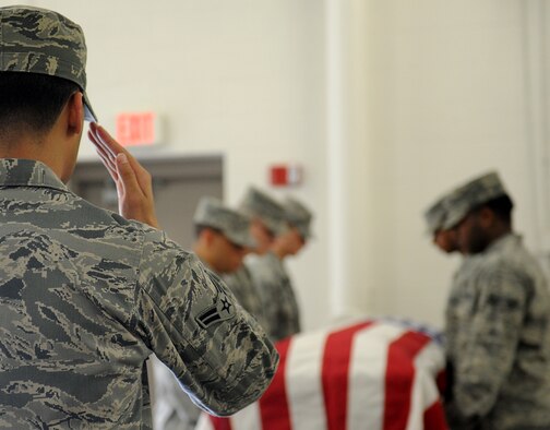 McConnell Honor Guard members practice proper flag folding sequences during a mock active duty funeral as part of the honor guard training program April 29, 2011, McConnell Air Force Base, Kan. Following eight days of specialized training by four members of the U. S. Air Force Honor Guard, McConnell Honor Guard members staged a 20-man mock active duty funeral during their graduation ceremony May 4. (U.S. Air Force Photo/Airman 1st Class Katrina M. Brisbin)