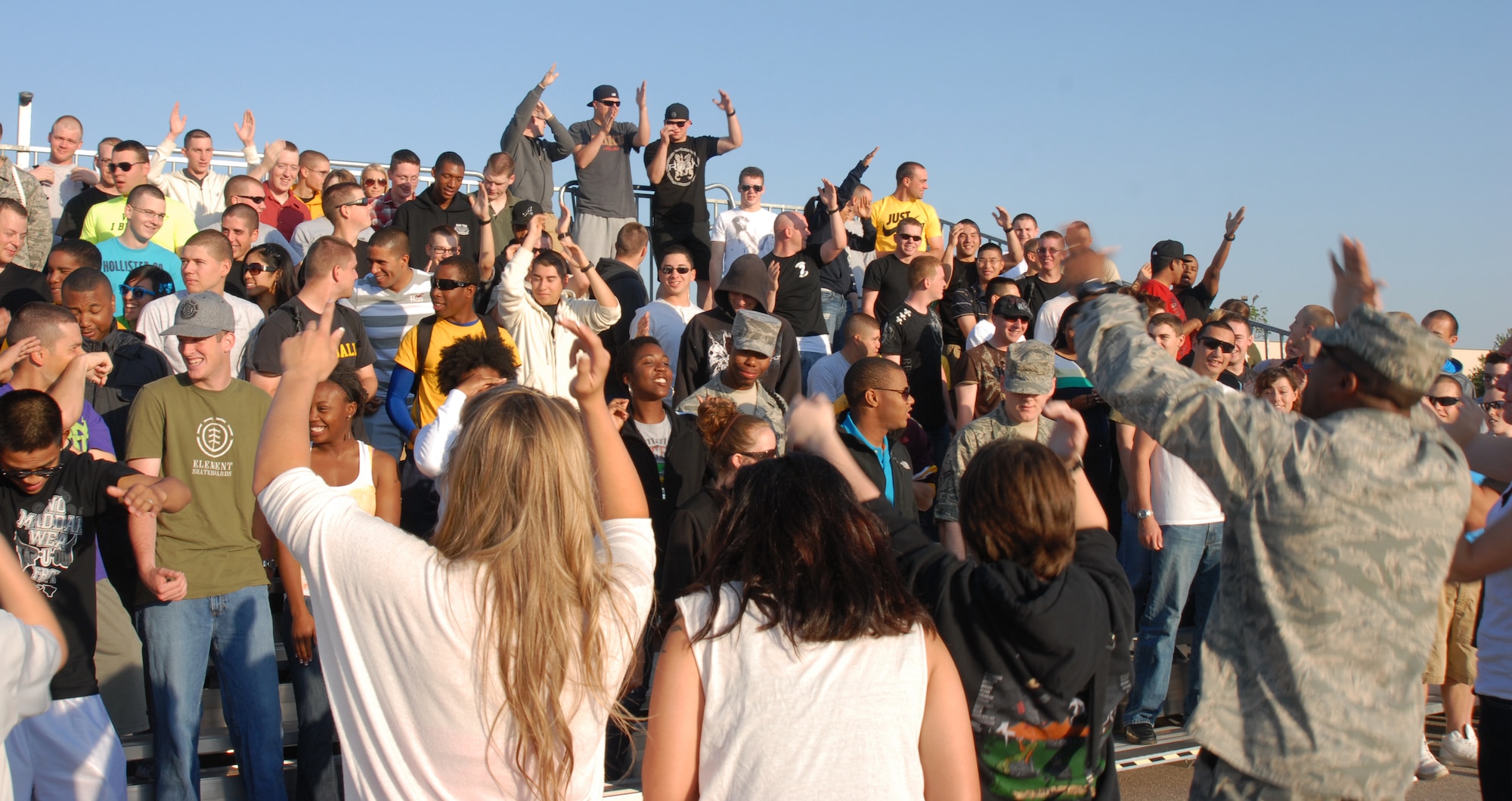 GOODFELLOW AIR FORCE BASE, Texas -- Maj. Sean Godfrey, 316th Training Squadron, pumps up the 316 TRS crowd at the drill team competition, May 7, 2011. The 316 TRS won the overall drill competition.(U.S. Air Force photo/Airman 1st Class Michael Smith)
