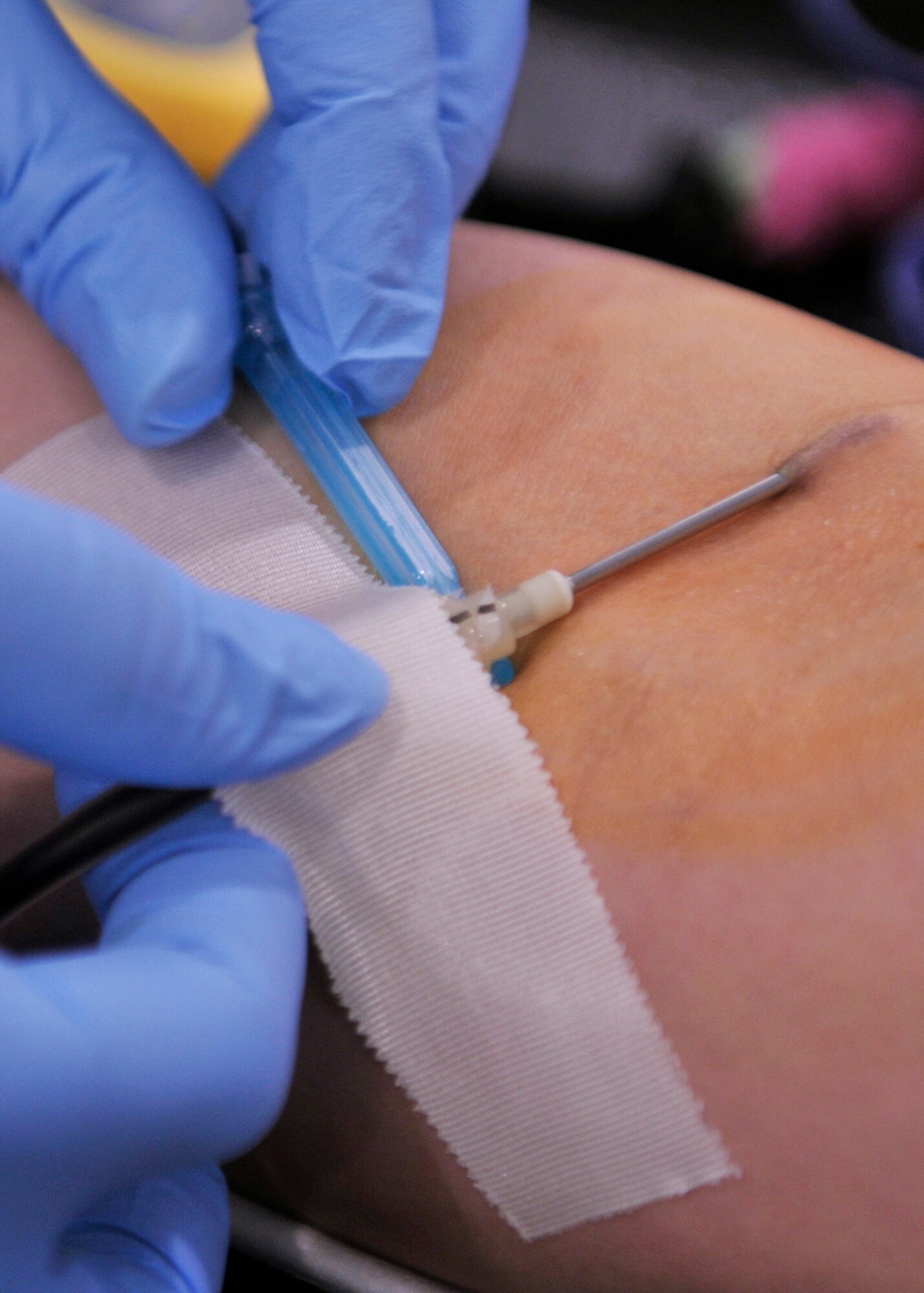 ROYAL AIR FORCE LAKENHEATH, England - Heather Youngblood, a phlebotomist from Landstuhl Regional Medical Center, Germany, inserts a needle into Airman 1st Class Elizabeth Dildy, 48th Aerospace Medical Squadron Bioenvironmental Engineering technician, during the Armed Services Blood Drive - Europe at the fitness center on May 10, 2011. Soldiers and civilians from LRMC came to RAF Lakenheath to collect the blood. LRMC blood drives are the largest contributors to the ASBD-E. (U.S. Air Force photo/Senior Airman Tiffany M. Deuel)