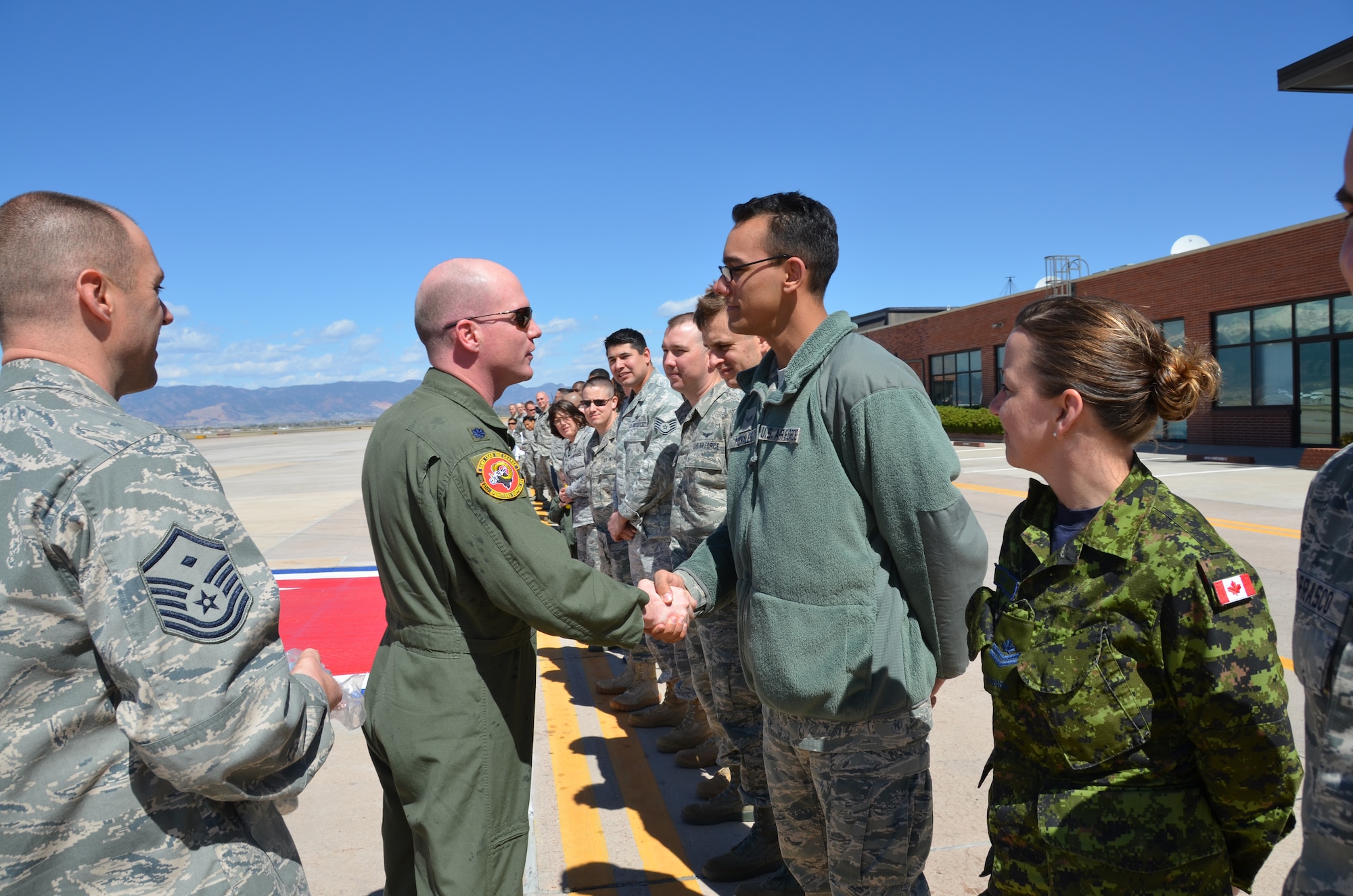 Airmen from the 21st Operations Support Squadron line the red carpet to wish Lt. Col. Troy Endicott well April 29, 2011. Colonel Endicott is the outgoing 21st Operations Support Squadron commander. (U.S. Air Force photo/Rollan Yocum)