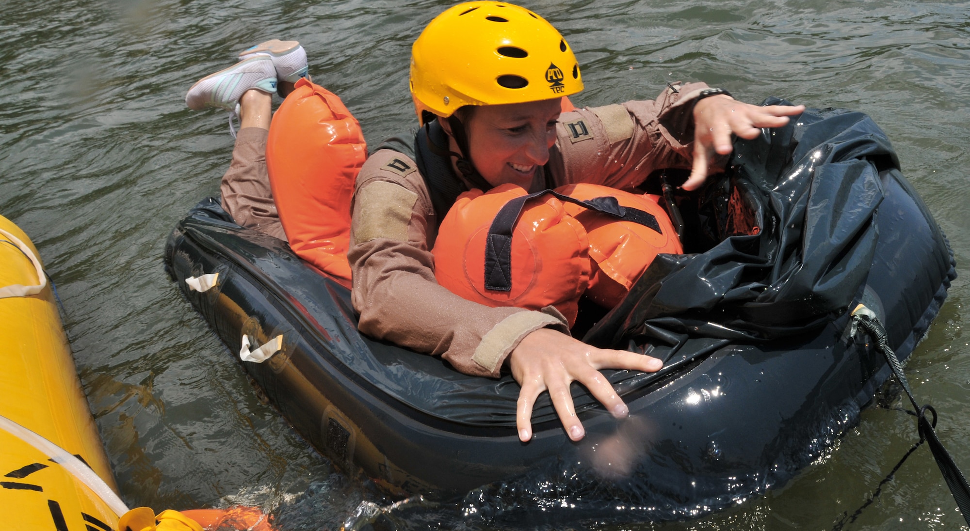 Capt. Amber Jackson boards a one-man life raft during a water survival training course May 2, 2011, at Charleston Harbor, South Carolina. Captain Jackson is a pilot assigned to the 14th Airlift Squadron at Joint Base Charleston. (U.S. Air Force photo/Airman 1st Class Jared Trimarchi)