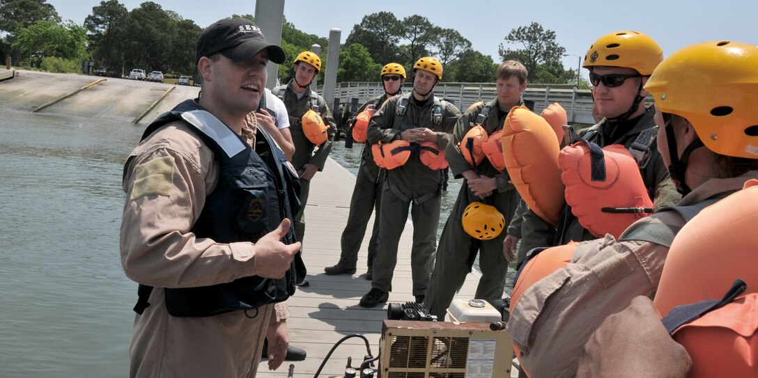 Staff Sgt. Anthony Barrette does a final safety brief before the Airmen board an inflatable boat during a water survival training course May 2, 2011, at Charleston Harbor, S.C. Sergeant Barrette is a survival, evasion, resistance and escape specialist from the 437th Operations Support Squadron at Joint Base Charleston. (U.S. Air Force photo/Airman 1st Class Jared Trimarchi)