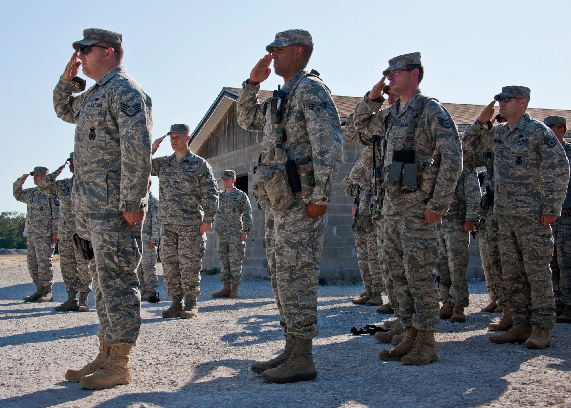 Chief Master Sgt. of the Air Force James A. Roy (middle left) and members of the 96th Ground Combat Training Squadron, salute the flag during retreat May 6 at Eglin Air Force Base, Fla.  The chief toured the squadron’s training facilities and experienced hands-on demonstrations like firing weapons and driving a humvee in a village with simulated improvised explosive devices.  (U.S. Air Force photo/Samuel King Jr.)