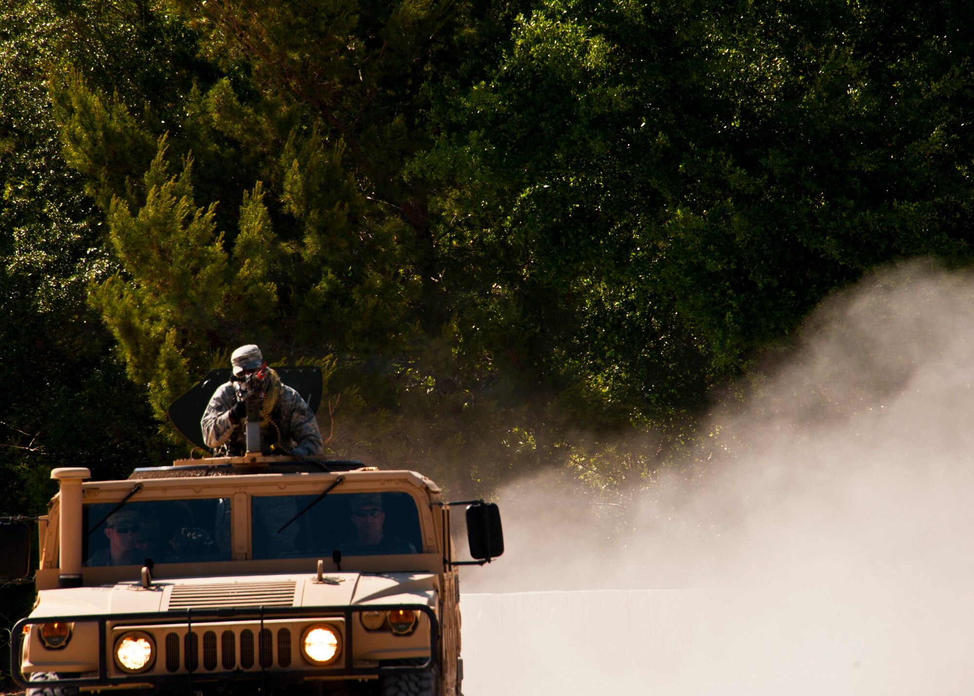 A humvee leaves a trail of dust as it moves toward a village as part of a assault demonstration by the 96th Ground Combat Training Squadron. The demonstration was for Chief Master Sgt. of the Air Force James A. Roy during his tour of the squadron facilities at Eglin Air Force Base, Fla., May 6. The chief received a hands-on “Brave Defender” experience with the 96th GCTS, firing weapons, watching demonstrations and driving a humvee through a village with simulated improvised explosive devices. (U.S. Air Force photo/Samuel King Jr.)