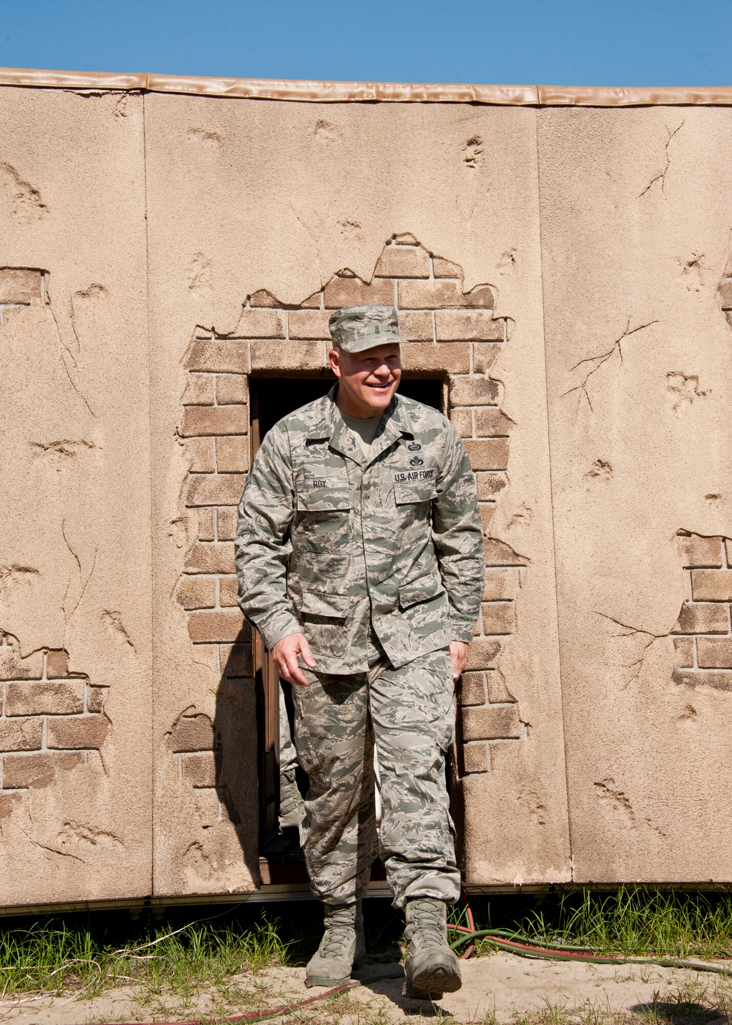 Chief Master Sgt. of the Air Force James A. Roy exits one of the houses in a simulated village during his tour of the 96th Ground Combat Training Squadron’s training area at Eglin Air Force Base, Fla., May 6.  The chief received a hands-on “Brave Defender” experience with the 96th GCTS, firing weapons, watching demonstrations and driving a humvee through a village with simulated improvised explosive devices.  (U.S. Air Force photo/Samuel King Jr.)