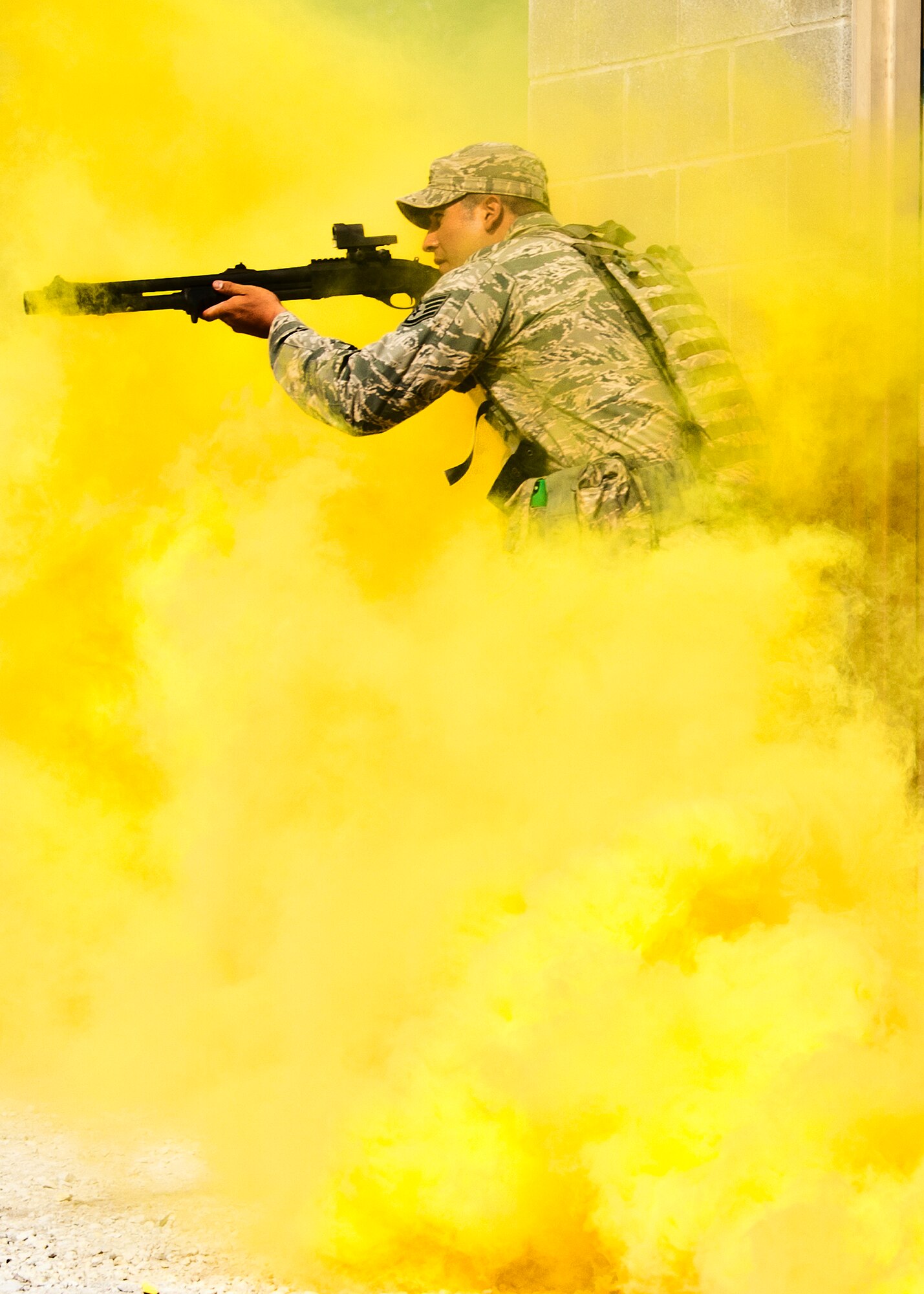 Staff Sgt. Geovanii Pacheco, 96th Ground Combat Training Squadron, leads his team out of the building as part of a assault demonstration by the 96th Ground Combat Training Squadron.  The demonstration was for Chief Master Sgt. of the Air Force James A. Roy during his tour of the squadron facilities at Eglin Air Force Base, Fla., May 6.  The chief received a hands-on “Brave Defender” experience with the 96th GCTS, firing weapons, watching demonstrations and driving a humvee through a village with simulated improvised explosive devices.  (U.S. Air Force photo/Samuel King Jr.)