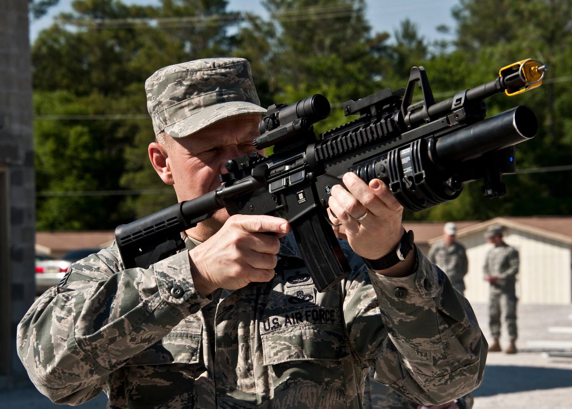 Chief Master Sgt. of the Air Force James A. Roy sights in his target with a specially equipped M-4 rifle at Eglin Air Force Base, Fla., May 6.  Checking out the newest weaponry was part of the chief’s tour of the 96th Ground Combat Training Squadron.  The chief took part in “Brave Defender” interactive tour firing weapons, watching demonstrations and driving a humvee through a village with simulated improvised explosive devices.  (U.S. Air Force photo/Samuel King Jr.)