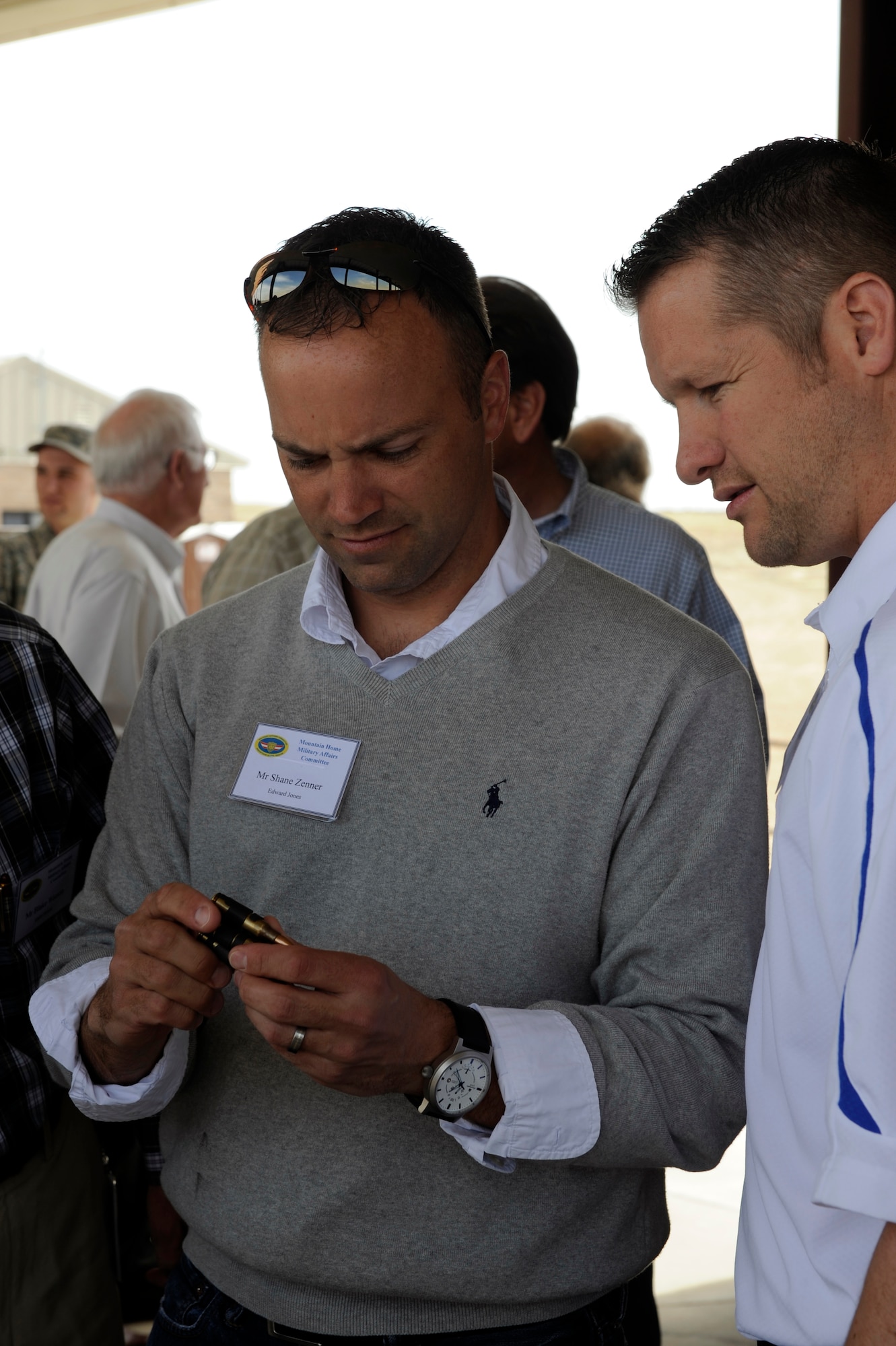 MOUNTIAN HOME AIR FORCCE BASE, Idaho – Mr. Shane Zenner, employee of Edward Jones, inspects the ammunition that has been put on display by the 366th Security Forces Squadron and the 366th Civil Engineer Squadron, during the Military Affairs Committee Immersion Day May 6. The MAC members were permitted to pick up and hold the weapons, feel their weight and inspect the ammunition that would be used by each weapon.  (U.S. Air Force photo by Angelina Drake)