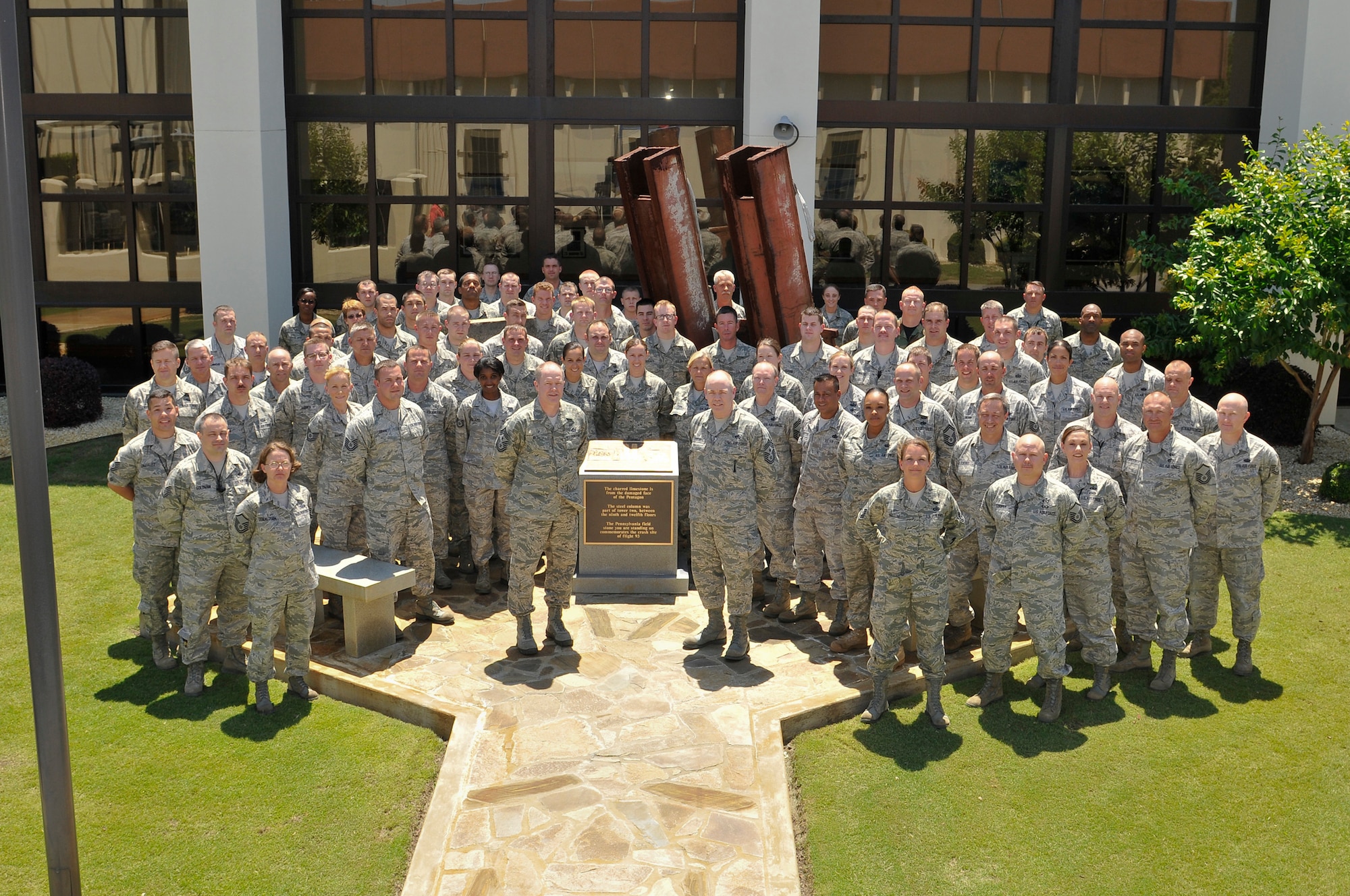 Chief Muncy and Chief Joe Thornell, 1AF/CCC, and members of 601st
Air Operations Center at their 9-11 Memorial. Steel beams from Twin Towers
are seen in back row.  Florida ANG, ANG, Air Force, AF Reserve, and Canadian
professionals guarding America's skies