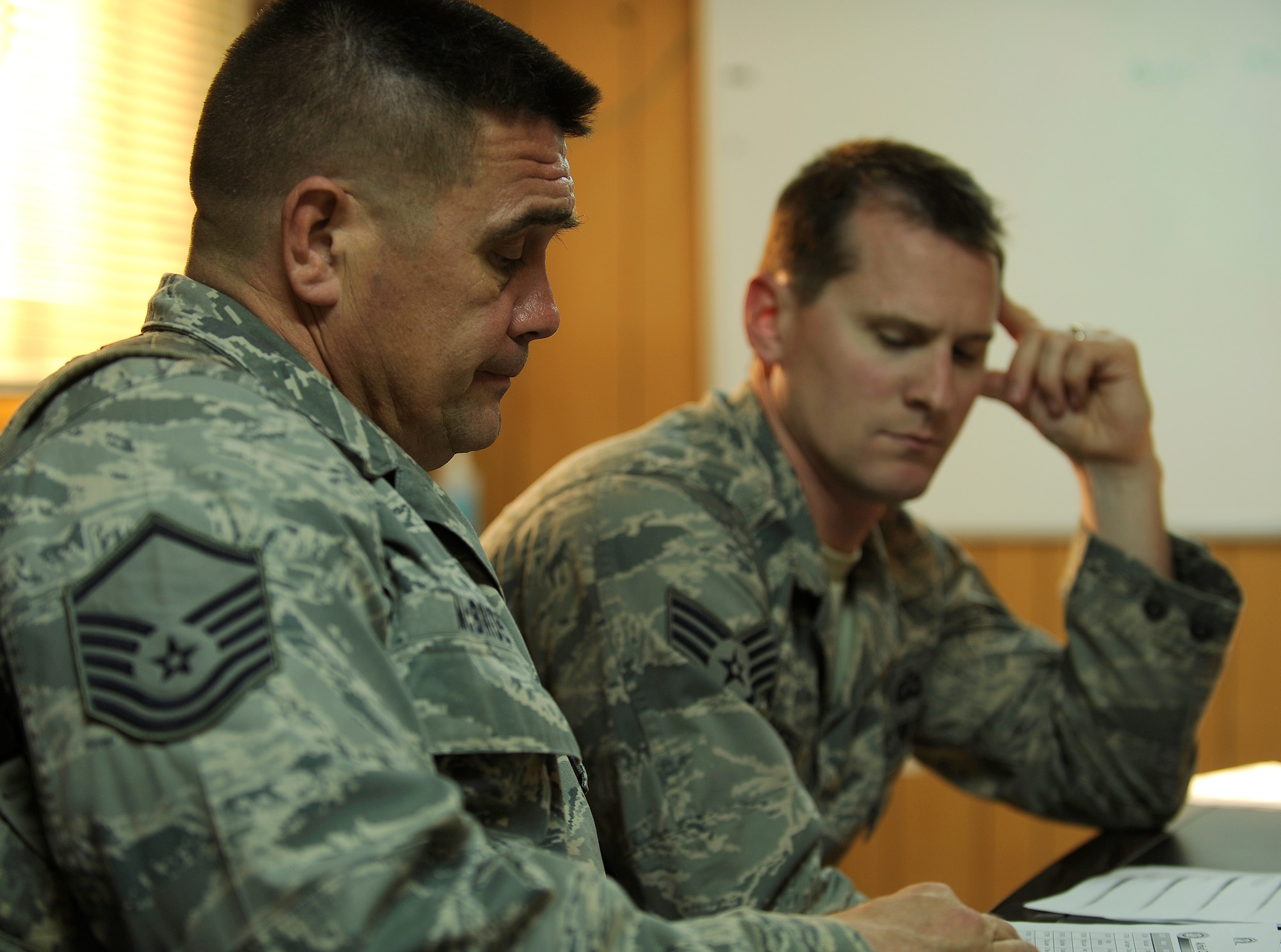 CAMP TAJI, Iraq – Master Sgt. Jerry McBride, left, and Staff Sgt. Andrew Lougheed, Iraq Training and Advisory Mission - Air advisors here, discuss plans with fellow air traffic controllers from Taji, Ali and Baghdad bases during a strategic planning meeting April 28. Sergeant McBride is deployed from Keesler Air Force Base, Miss., and hails from Bronson, Texas. Sergeant Lougheed is deployed from Elmendorf AFB, Alaska, and calls Medford, Ore., home. (U.S. Air Force/Tech. Sgt. Jason Lake)