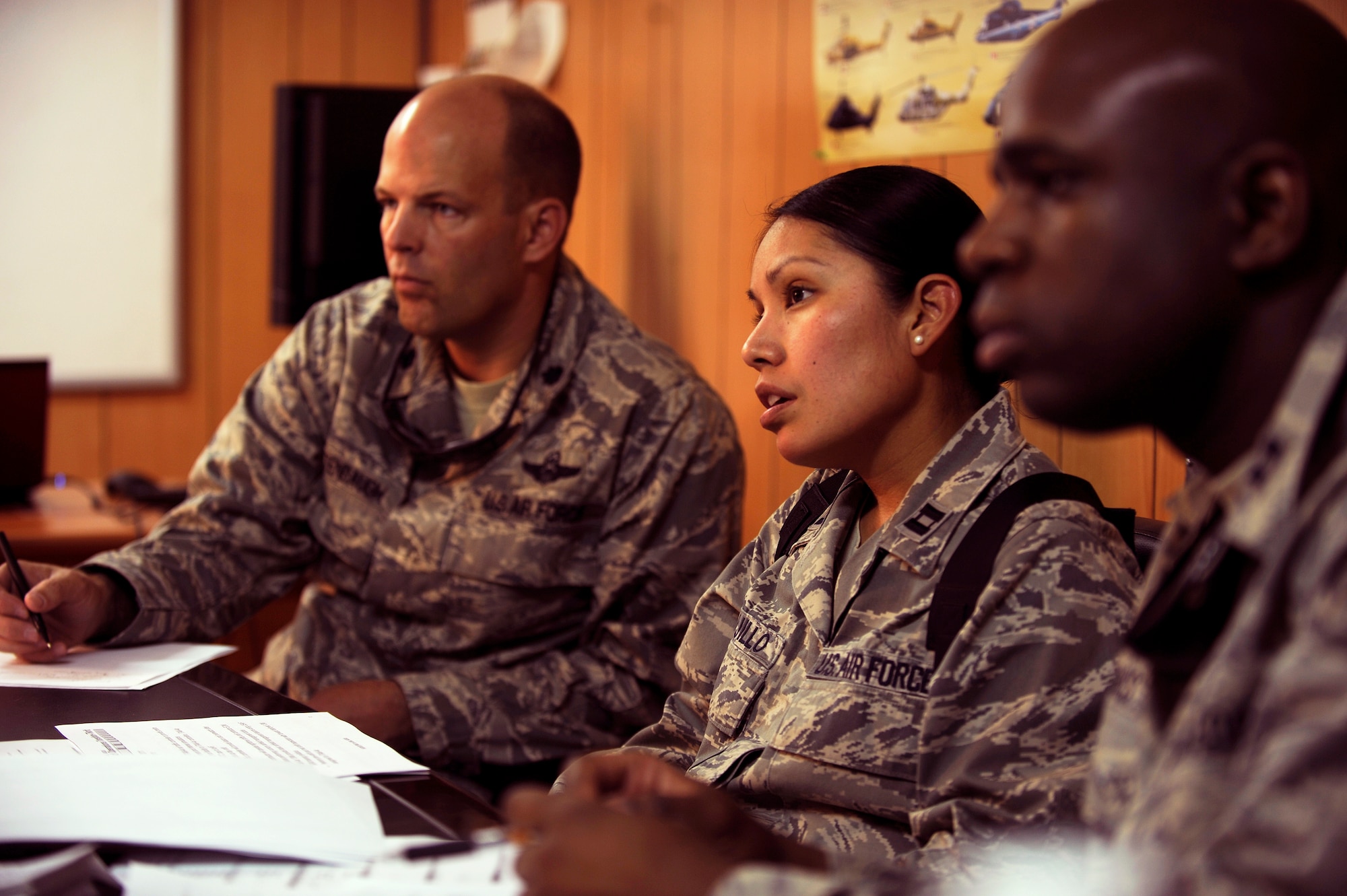 CAMP TAJI, Iraq -- Lt. Col. Daniel Kaltenbaugh, left, and Capts. Maureen Trujillo, center, and Robert Hughes, Iraq Training and Advisory Mission – Air advisors, discuss plans with fellow air traffic controllers from Taji, Ali and Baghdad bases during a strategic planning meeting here April 28. Colonel Kaltenbaugh is deployed from Kadena Air Base, Japan, and is a Sandy Lake, Pa., native. Captain Trujillo is returning to Dyess AFB, Texas, and calls Cochiti Pueblo, N.M., her hometown. Captain Hughes is deployed from Maxwell Air Force Base, Ala., and hails from Chesterfield County, Va. (U.S. Air Force/Tech. Sgt. Jason Lake)