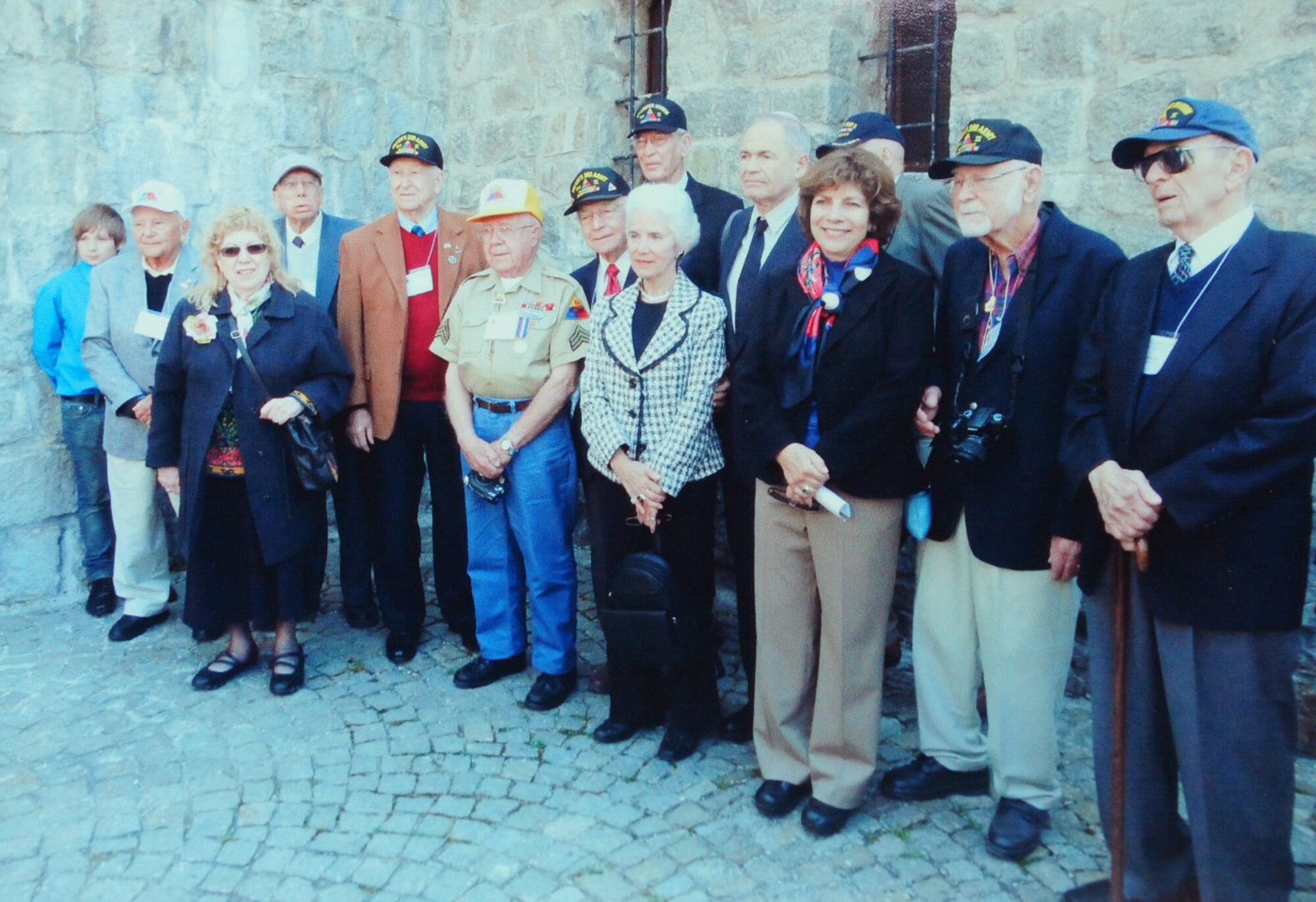 MAUTHAUSEN, Austria -- The surviving veterans of the 11th Armoured Division -- the U.S. Army unit which liberated the concentration camp in 1945 -- pose for a photo in 2010 with Eva Clarke, Hannah Berger-Moran and Mark Olsky (all now 65), all three of whom were babies born on a coal truck on its way to a concentration camp in Mauthausen, Austria. They were all born just days before the 11th Armoured Division liberated the camp. (Courtesy photo)