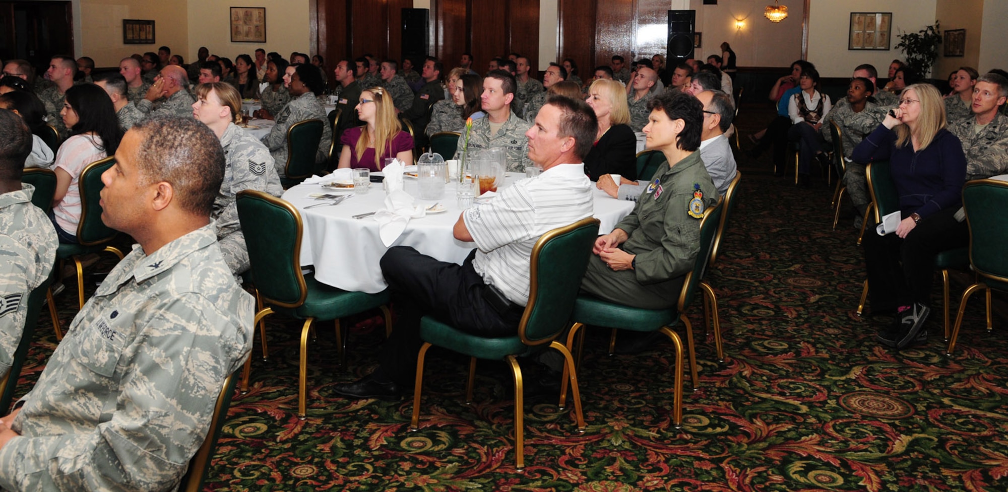 RAF LAKENHEATH, England -- The Eagles' Landing at RAF Lakenheath is packed to capacity as Eva Clarke, Holocaust survivor, speaks at a luncheon May 6, 2011. Mrs. Clarke shared the story of what her parents went through during the Holocaust, when they were kept prisoner in concentration camps. (U.S. Air Force photo/Karen Abeyasekere)