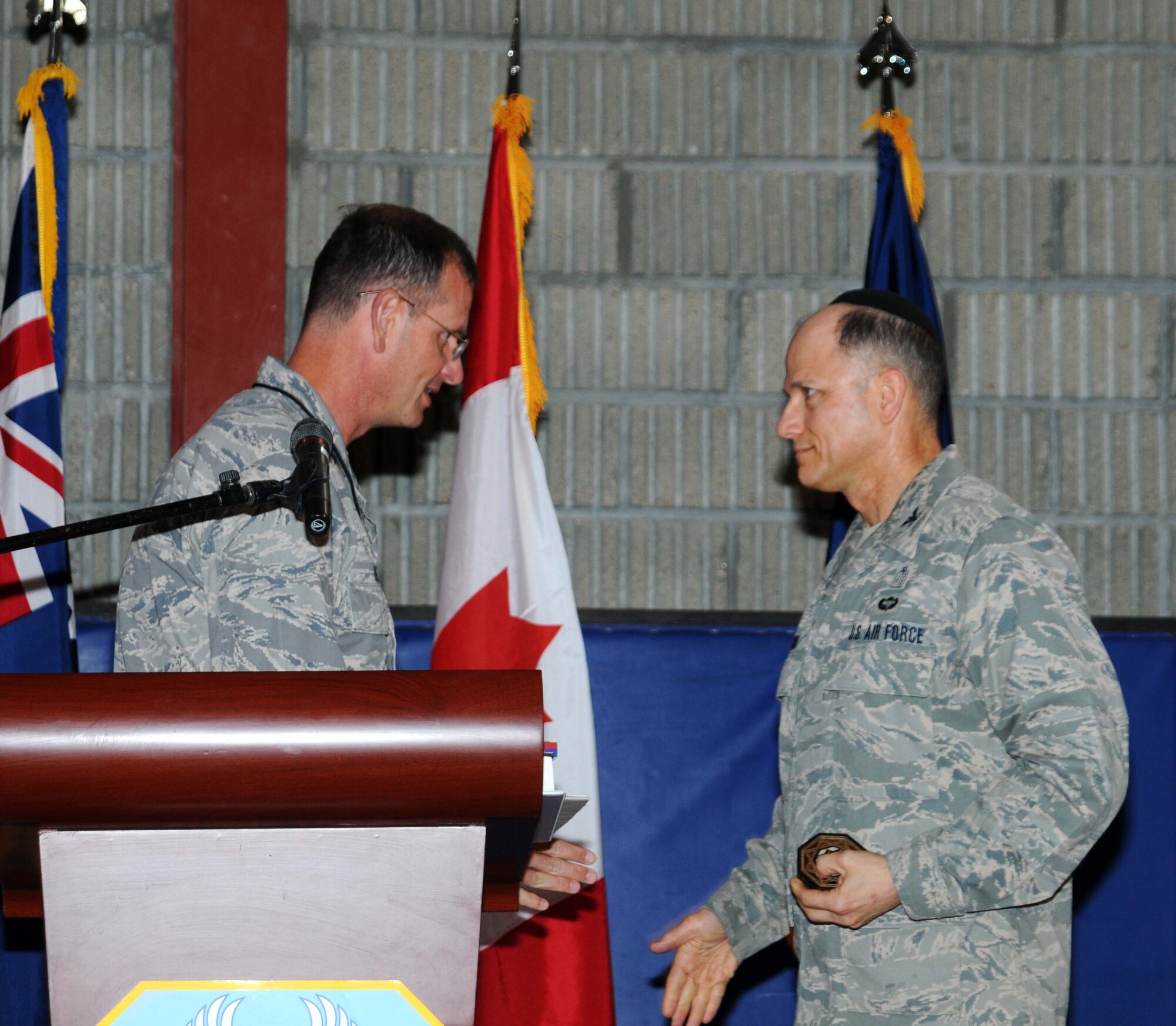 379th Air Expeditionary Wing Commander BG Randy Kee shakes hands with Col Brett Oxman May 10 during a Prayer Breakfast in Southwest Asia. Col Oxman was the guest speaker for the day's event. (U.S. Air Force photo/ Staff Sgt. Anthony Graham)
