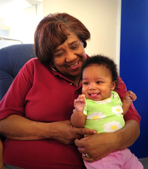 Melba Lee, 86th Force Support Squadron child development center lead program assistant, poses for a photo with Asia, 5 months, daughter of Tech. Sgt. Latonia Booze, U.S. Air Forces in Europe management analyst, Ramstein Air Base, Germany, April 13, 2011. (U.S. Air Force photo by Senior Airman Brittany Perry)