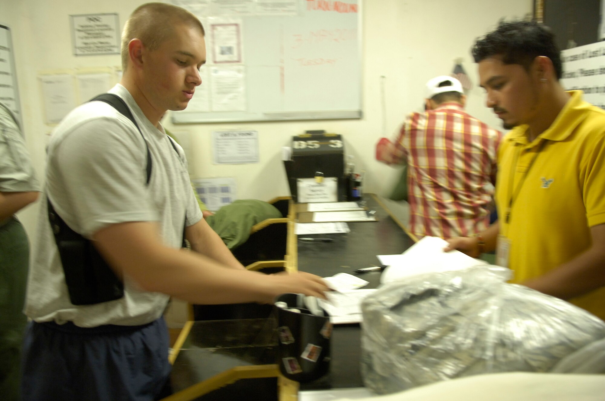 SATHER AIR BASE, Iraq – Staff Sgt. Thomas Dement, 447th Expeditionary Security Forces Squadron patrol leader, picks up his clean clothes from the laundry May 4. People at Sather should expect major changes in services over the coming months, including a new location for laundry services and other facilities. (U.S. Air Force photo by Tech. Sgt. Randy Redman) 