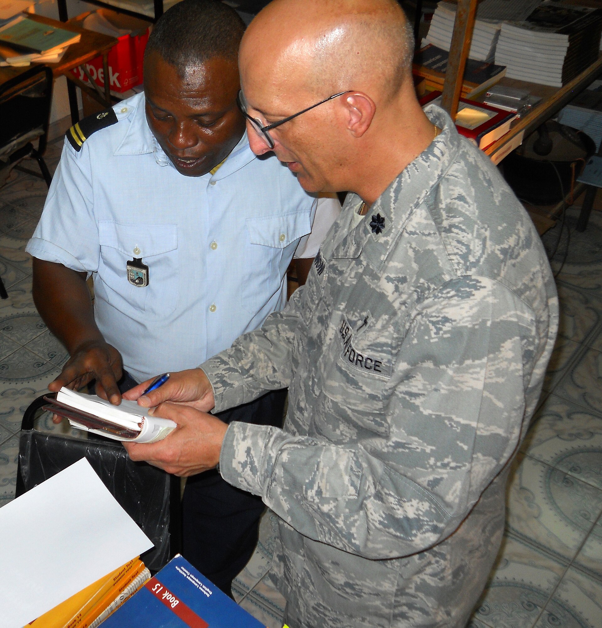 MORONI, Comoros – Combined Joint Task Force–Horn of Africa (CJTF-HOA) Chaplain (U.S. Air Force Lt. Col.) David Terrinoni (right) exchanges contact information with Comoros Gendarmerie 1st Lieutenant Taoufique Housseine, head English instructor for the Ecole Nationale Des Forces Armees et de La Gendarmerie (ENFAG) in Comoros, after speaking with him about his faith and travels to the United States. Terrinoni traveled to Uganda, Comoros and Kenya to celebrate Holy Week with deployed members of CJTF-HOA. For Christians, Holy Week occurs during the week before Easter and consists of Palm Sunday, Good Friday and other days Christians celebrate their faith. (U.S. Air Force photo by Maj. Khalid Cannon)