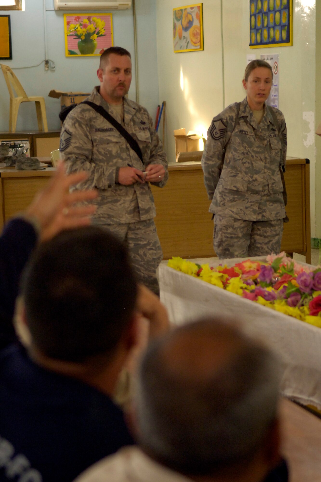 NEW AL MUTHANA AIR BASE, Iraq – Master Sgt. Daryl Baldosser, 447th Expeditionary Communications Squadron Cyber Transport Systems section chief, left, and Master Sgt. Christina Riegel, 447th Expeditionary Logistics Readiness Squadron Traffic Management superintendent, listen as an Iraqi airman asks a question during a non-commissioned officer professional development course April 27. Airmen with the Iraq Training and Advisory Mission-Air and 447th Air Expeditionary Group taught the course to help the IqAF develop its NCOs into stronger leaders. Sergeant Baldosser, deployed from Joint Base Lewis-McChord, Wash., is originally from Republic, Ohio. Sergeant Riegel, deployed from Ramstein Air Base, Germany, is originally from Greeley, Colo. (U.S. Air Force photo by Tech. Sgt. Randy Redman)