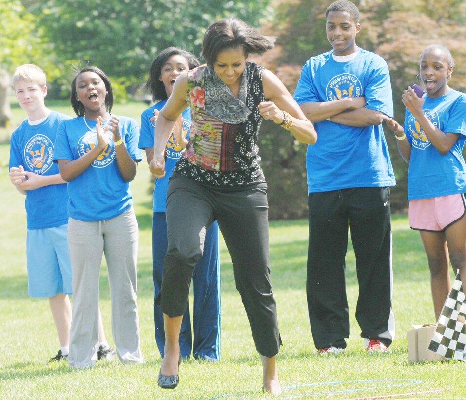 First Lady Michelle Obama navigates an obstacle course during a fitness ...