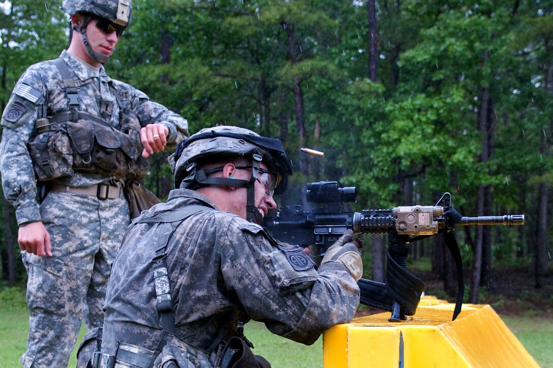 An Army paratrooper fires at a target with his M4A2 carbine during a ...